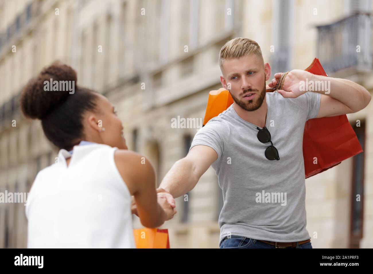 woman dragging her man or boyfriend to do shopping Stock Photo Alamy