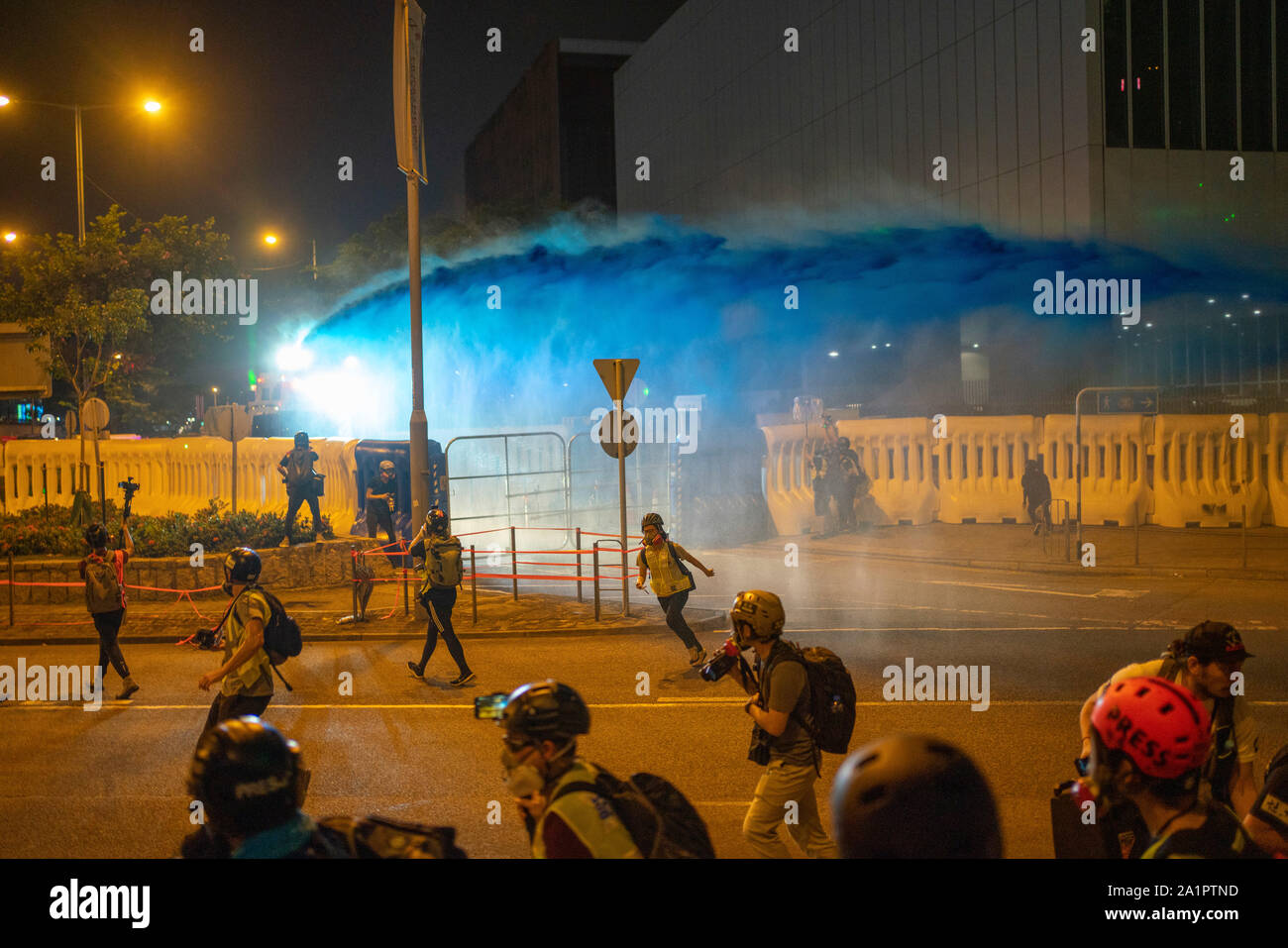 Hong Kong. 28 September 2019. Police fire water cannon at demonstrators outside the Government Headquarters at Tamar in Admiralty district of the city. The water is dyed blue and is laced with a stinging ingredient. Crowds had gathered at Tamar to commemorate 5th anniversary of Umbrella Movement. Small group of protestors provoked police away from the rally. Iain Masterton/Alamy Live News Stock Photo