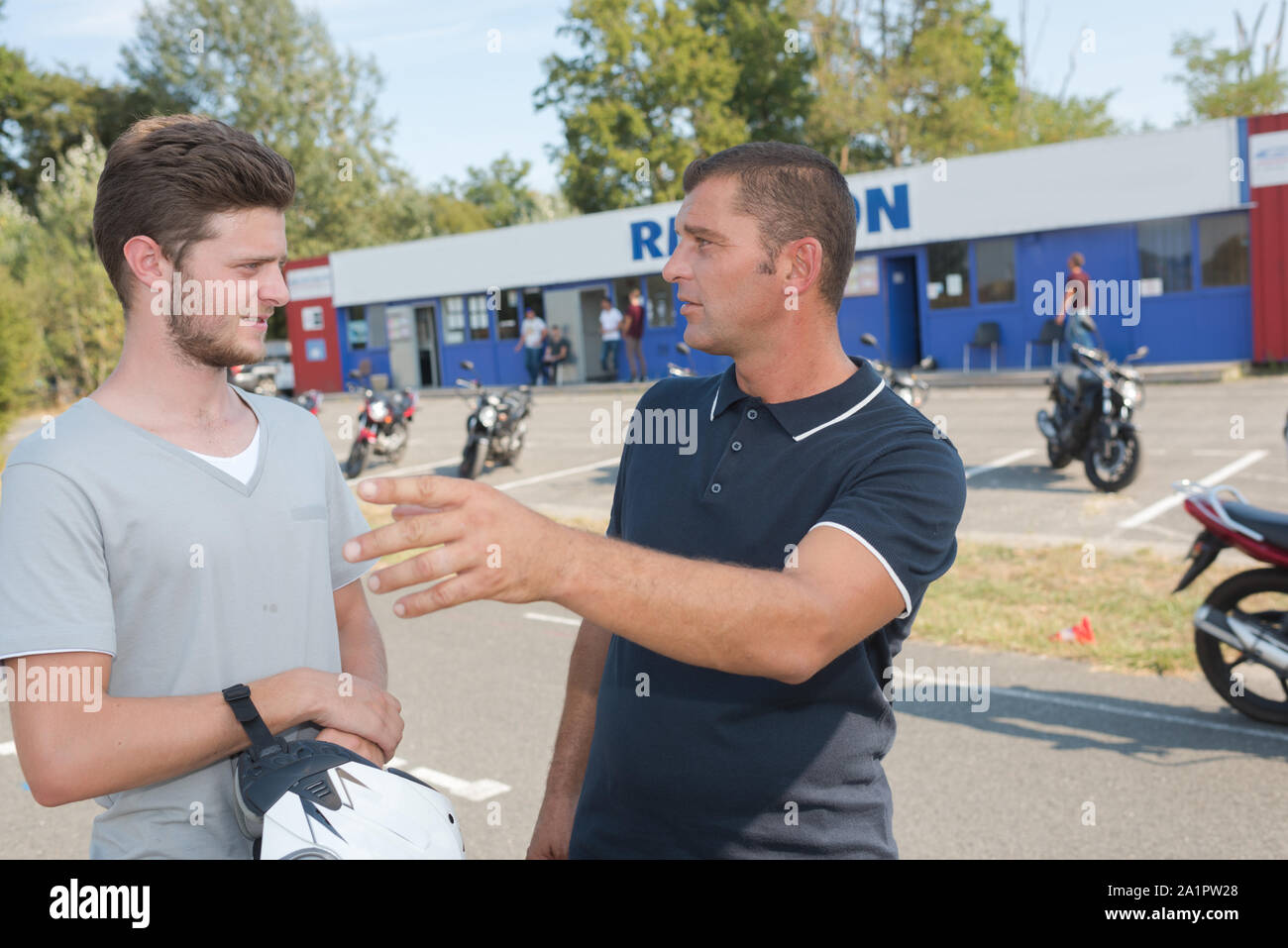 conversation outside the motorbike training center Stock Photo