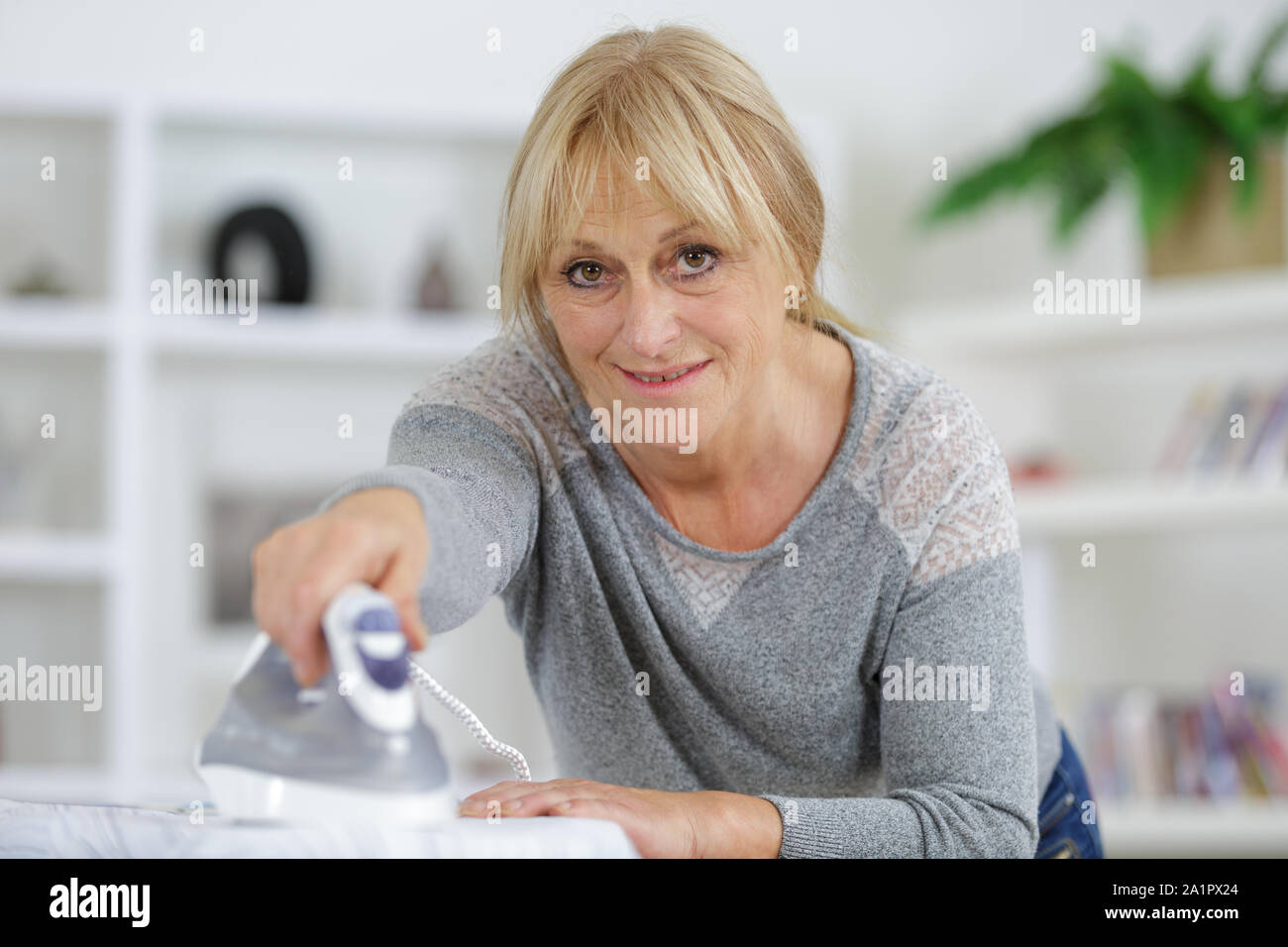 matuure designer using iron while working in studio Stock Photo