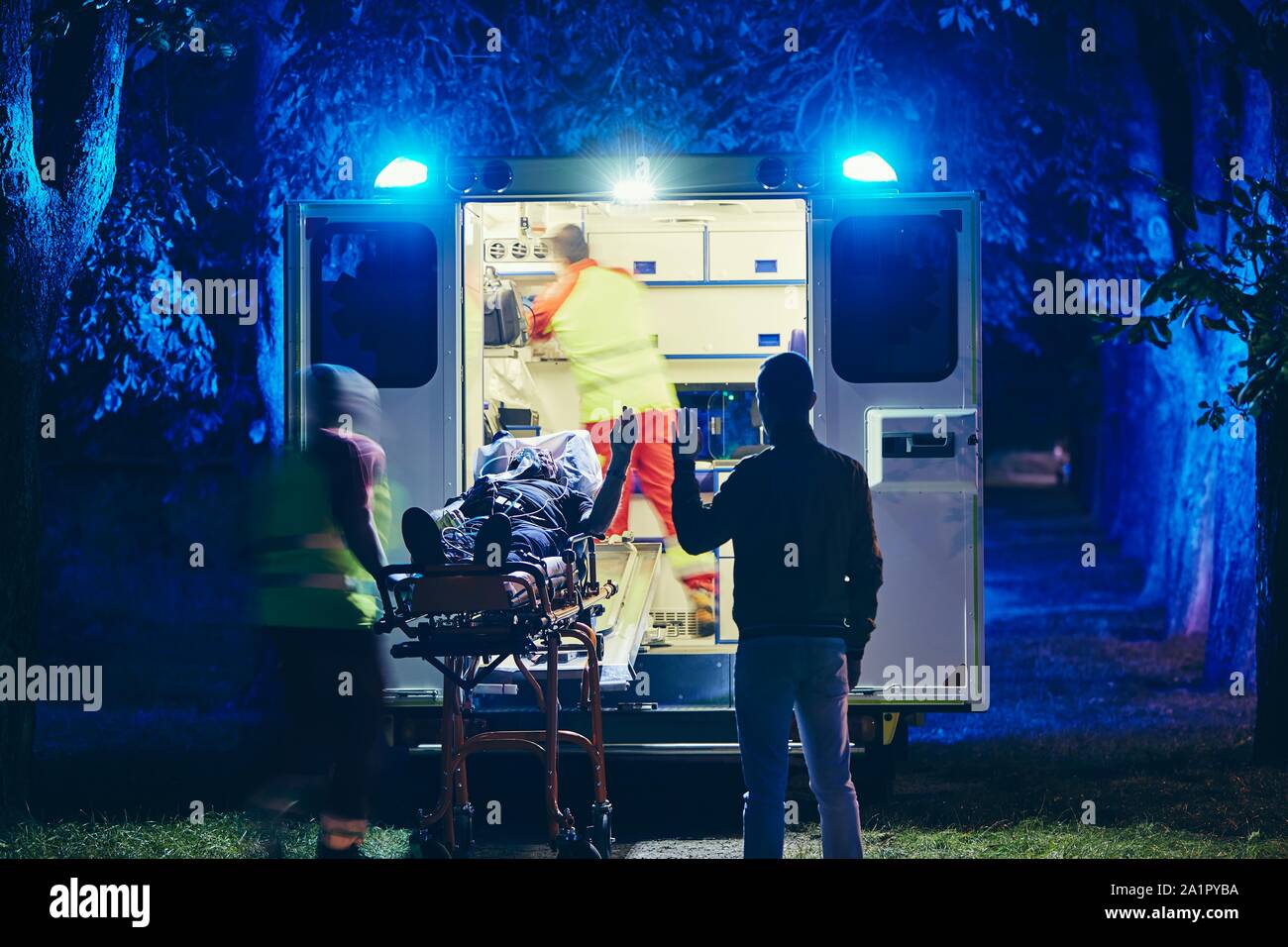 Doctor and paramedic of emergency medical service take care of old ill man. Team of emergency medical service rescuing old patient. Concepts health ca Stock Photo