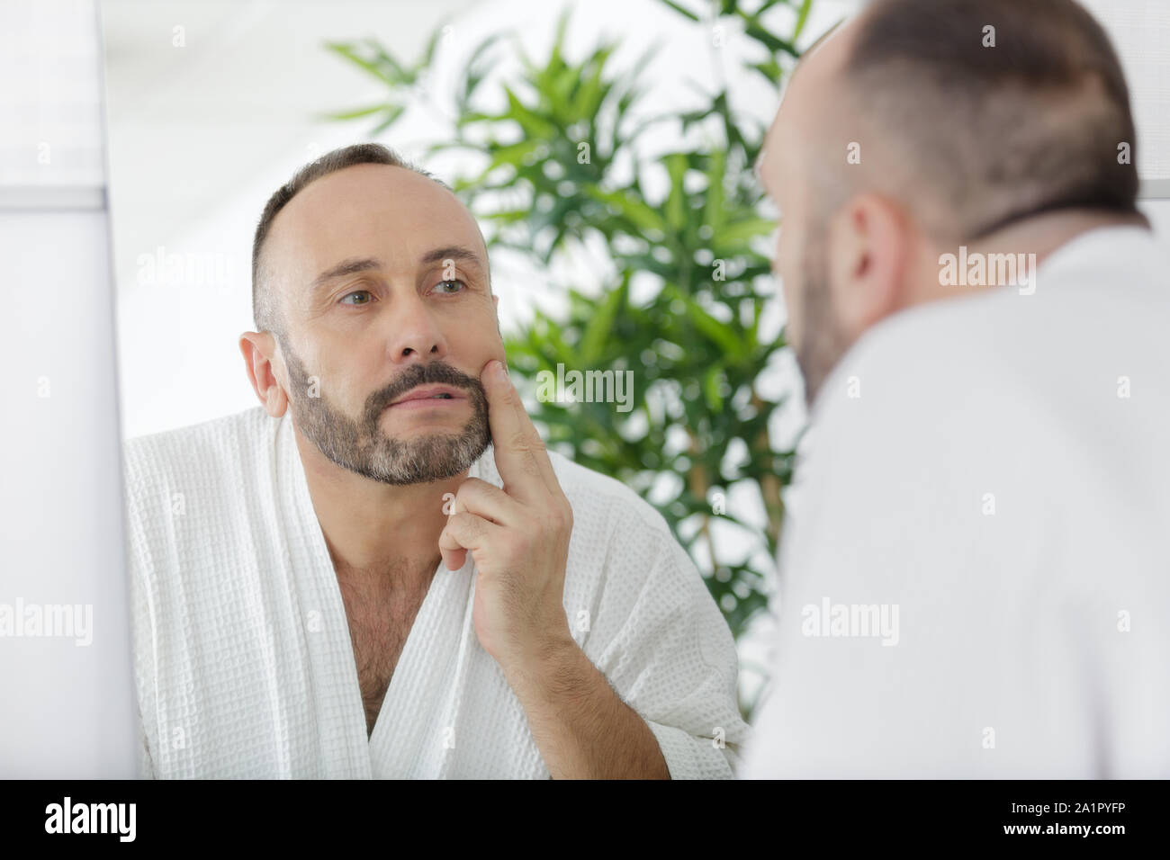 Man Touching Beard And Face Looking In Mirror Stock Photo Alamy Man Touching Beard And Face Looking In Mirror Stock Photo Alamy