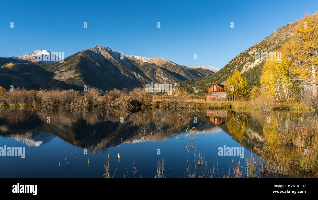 Old cabin by lake in Autumn colors Stock Photo