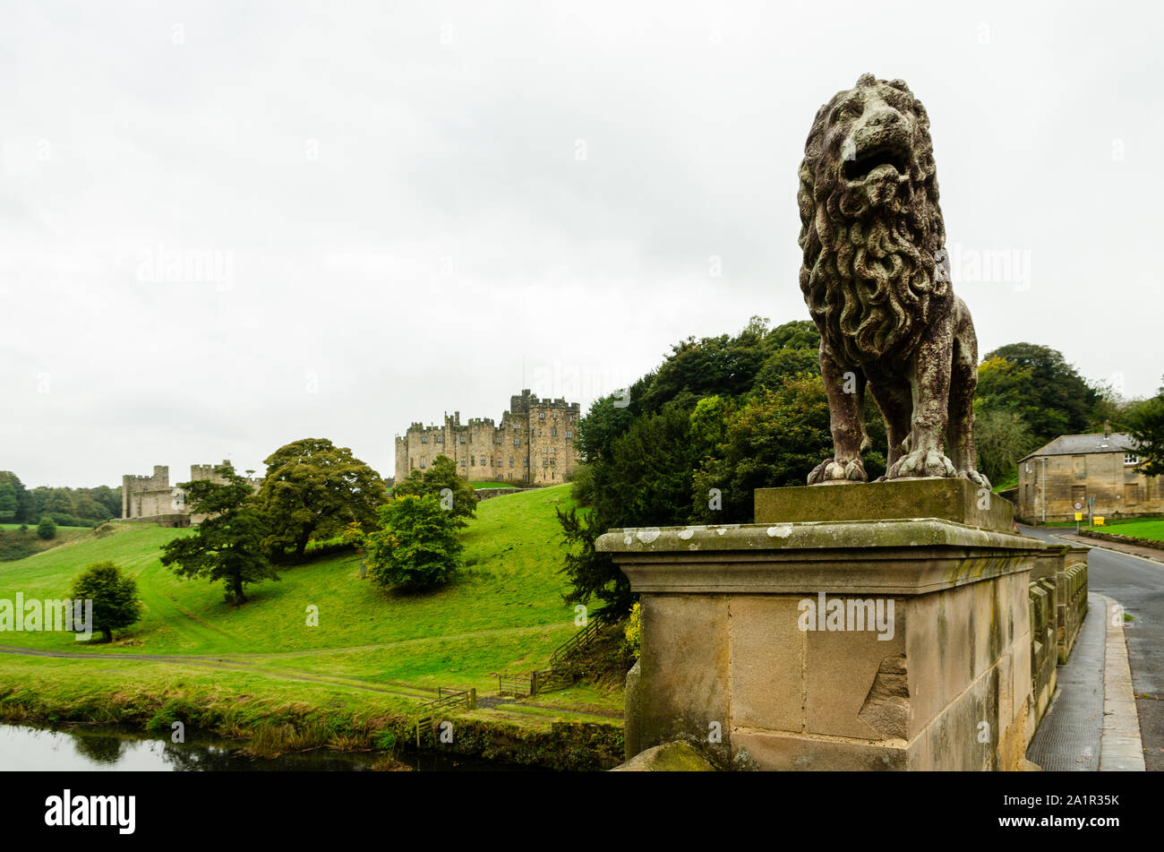 Lion statue on the Lions Bridge outside Alnwick Castle in Alnwick, Northumberland, UK Stock Photo