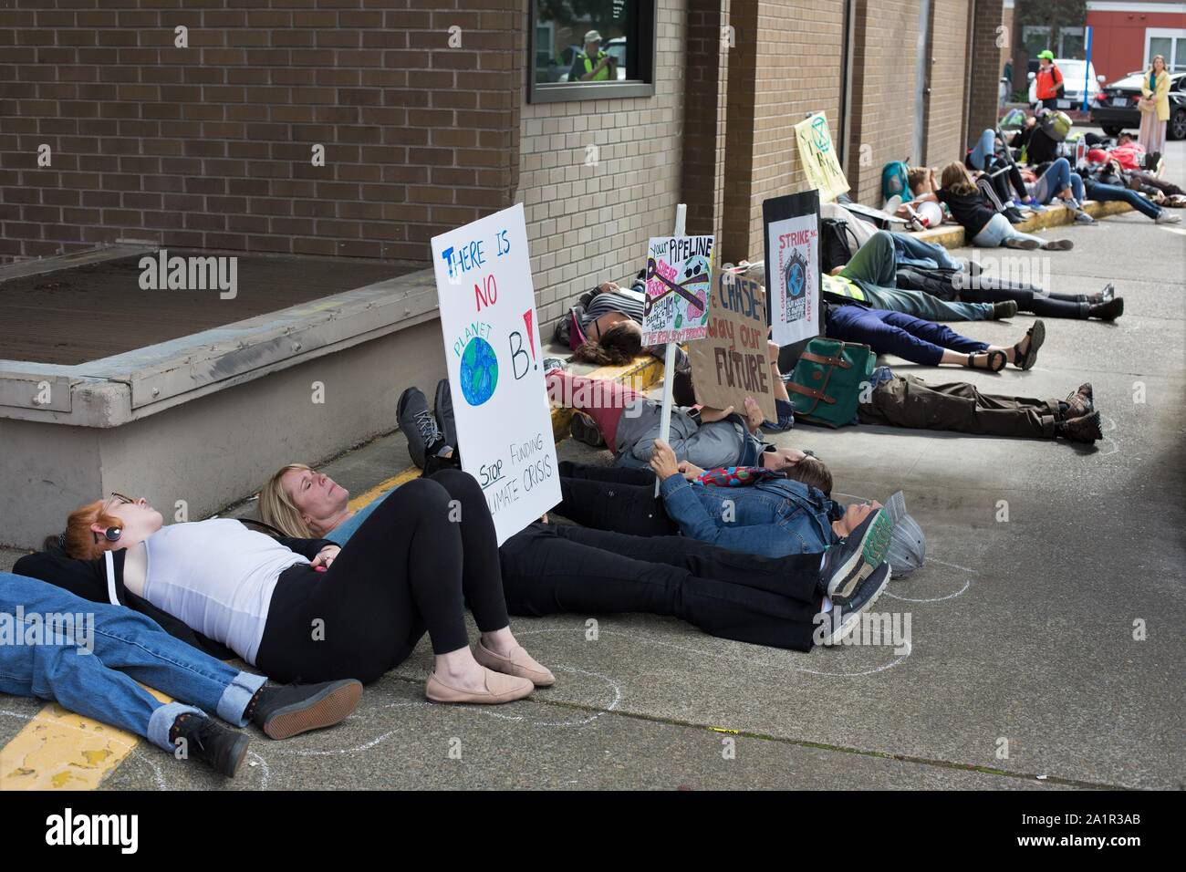 Climate activists perform a die-in at Chase Bank in Eugene, Oregon, USA. Stock Photo