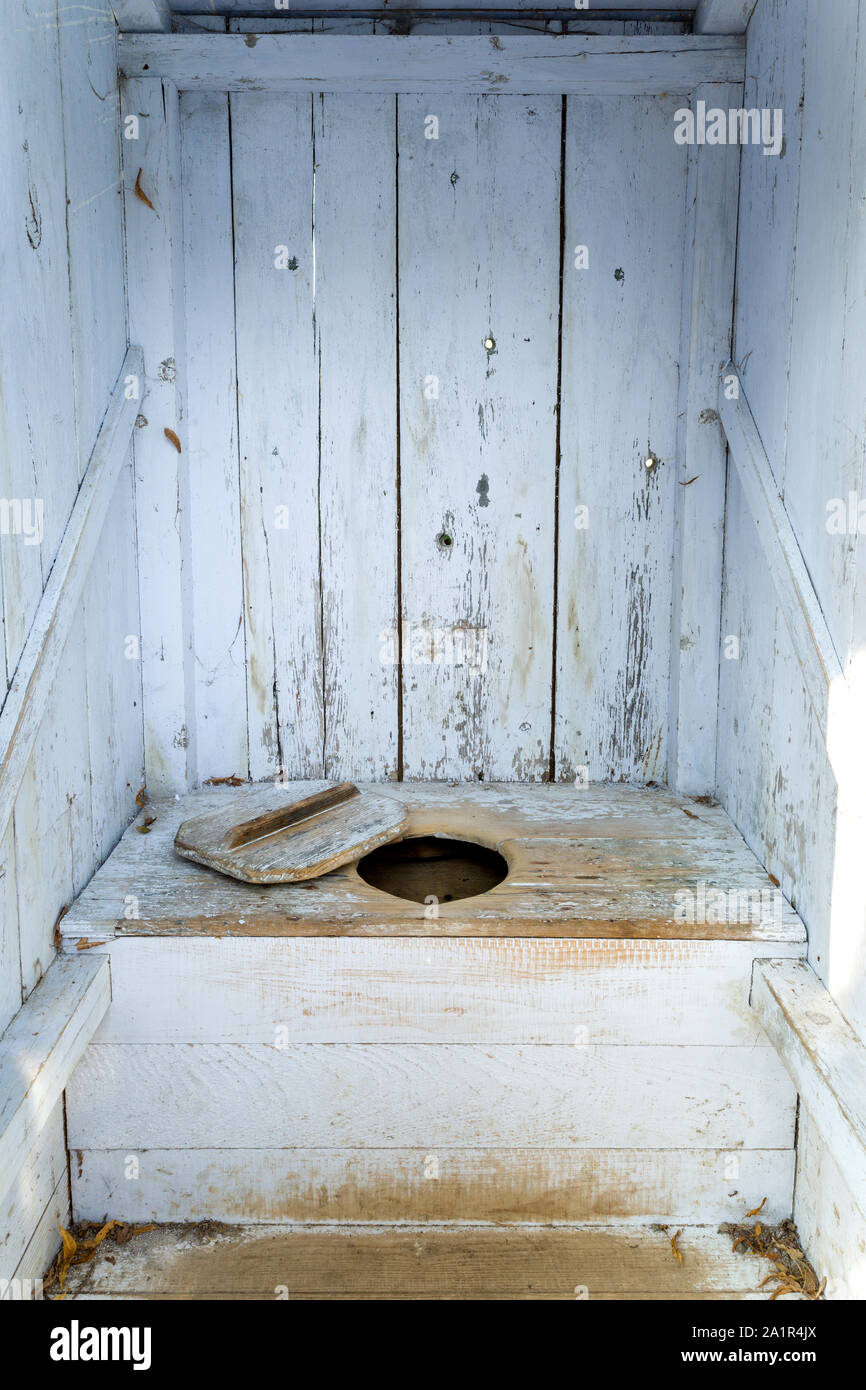 interior of an old wooden outhouse Stock Photo