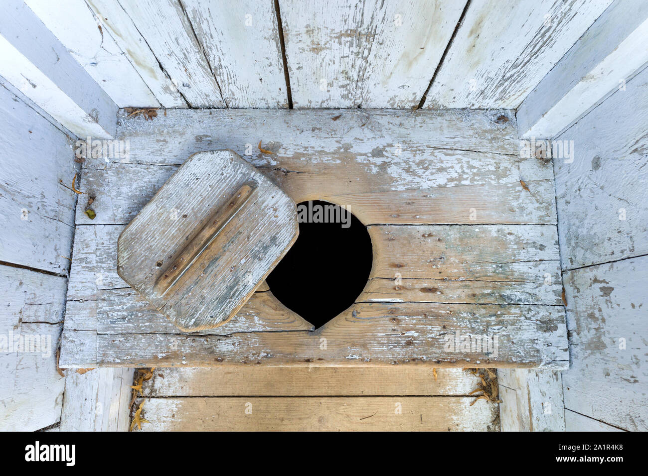 interior of an old wooden outhouse Stock Photo
