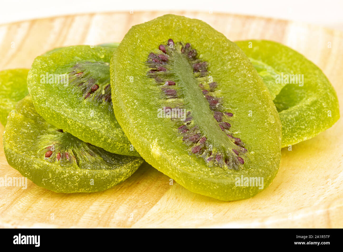 Dehydrated (dried) sliced natural green wiki on wooden plate closed-up  Stock Photo - Alamy