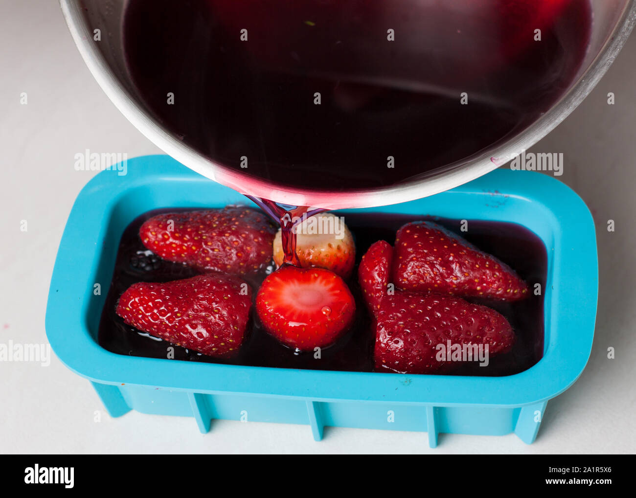 Preparation of fruit jelly terrine with berries. Pouring hibiscus and