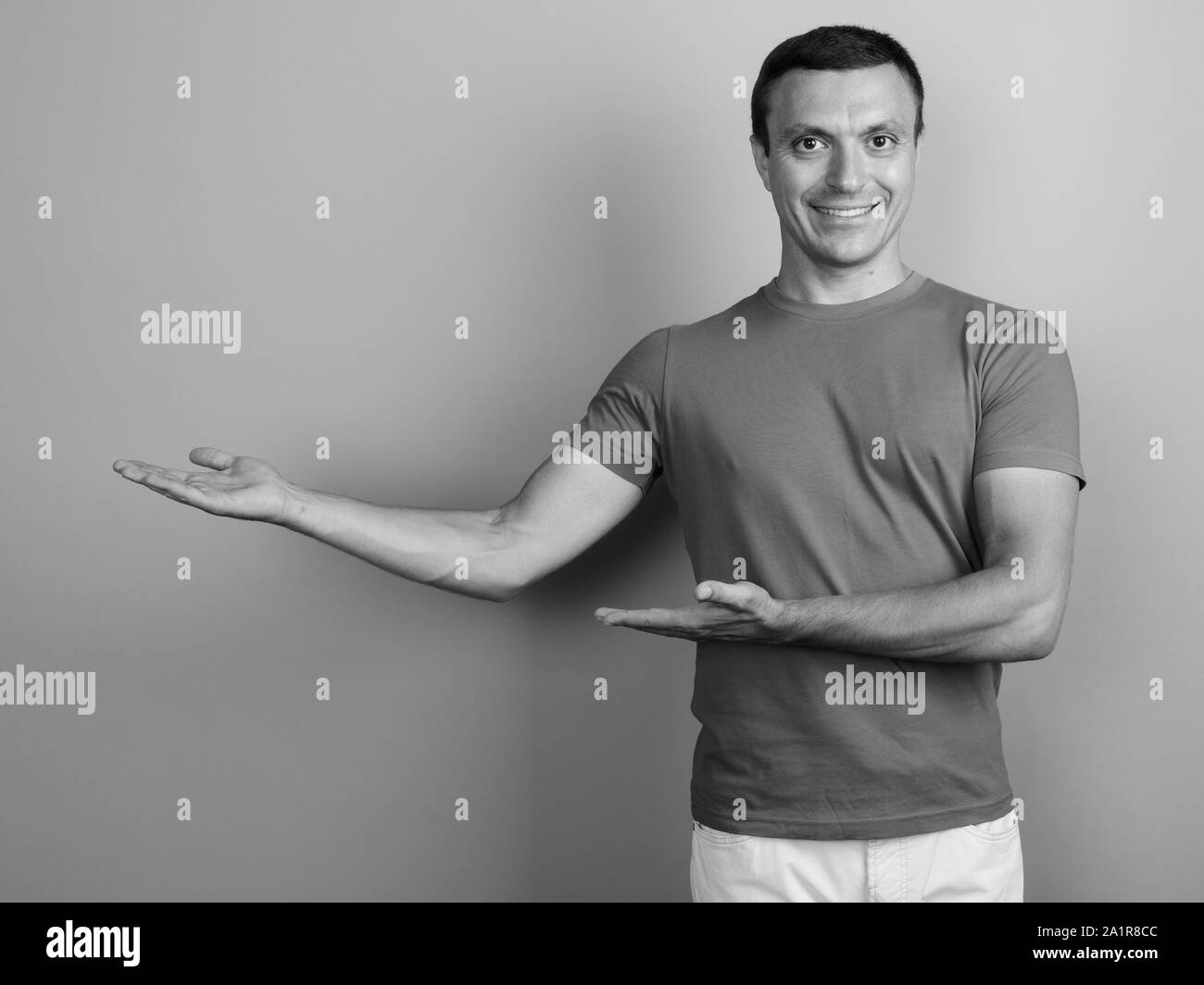 Man showing his t shirt Black and White Stock Photos & Images - Alamy