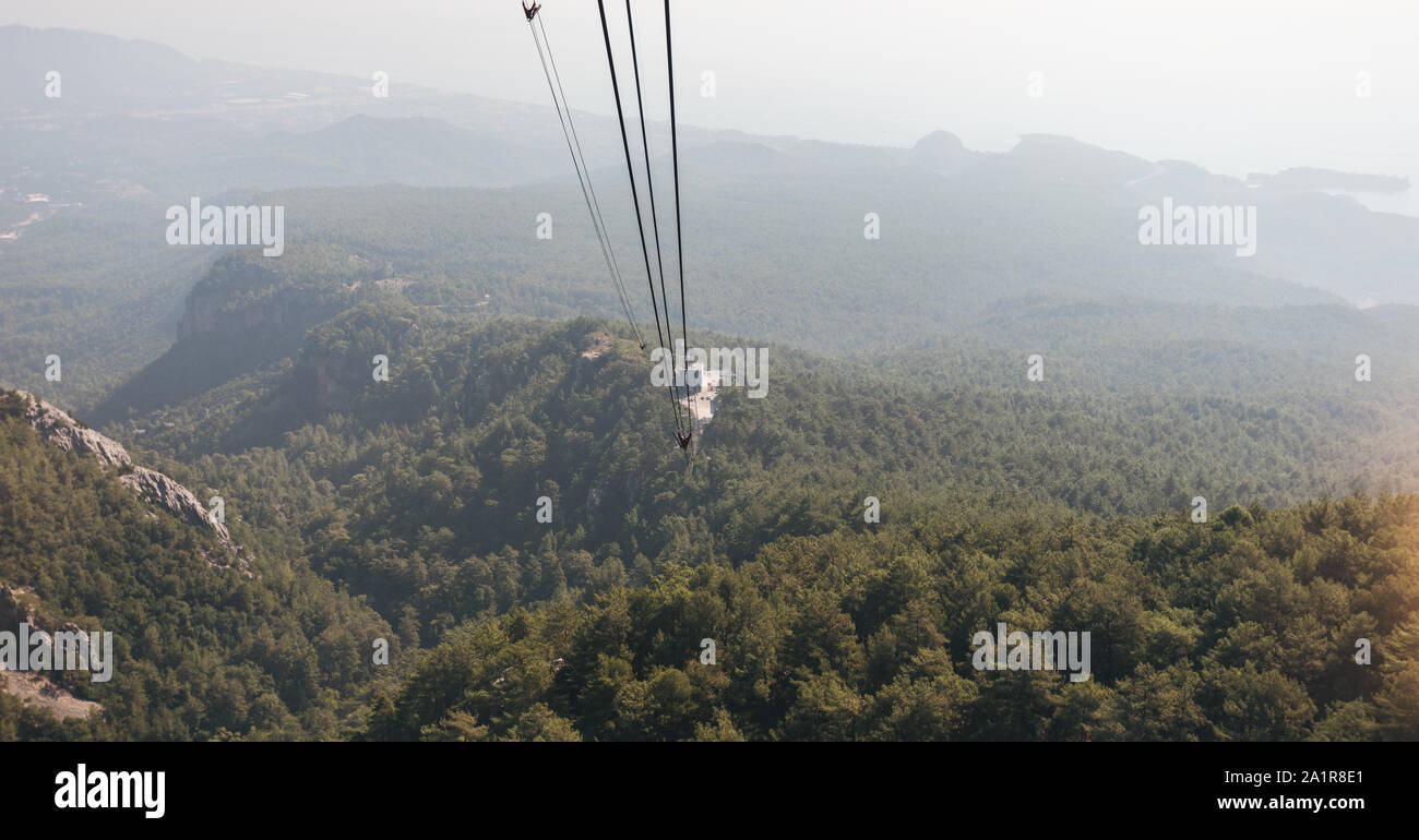 Mountain views from the cable car cabin to the top of Tahtali and the sea near the coast of Kemer, Antalya, Turkey Stock Photo
