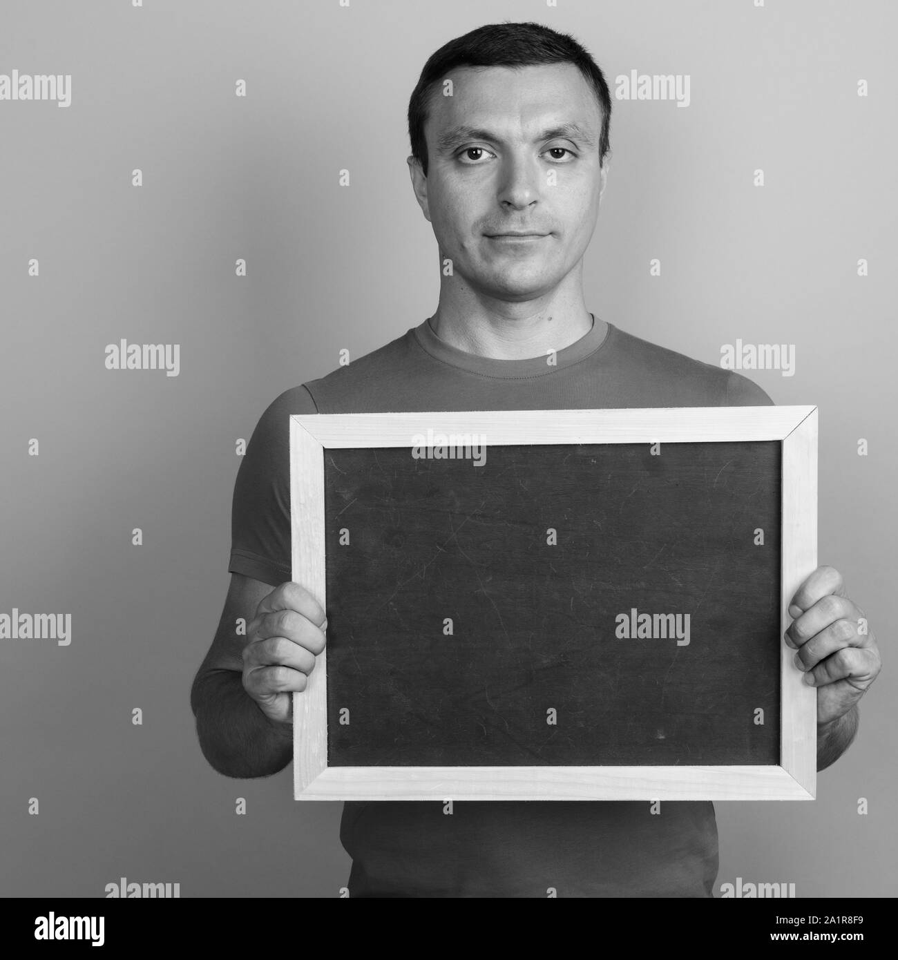 Man Wearing T shirt Against Gray Background Shot In Black And White