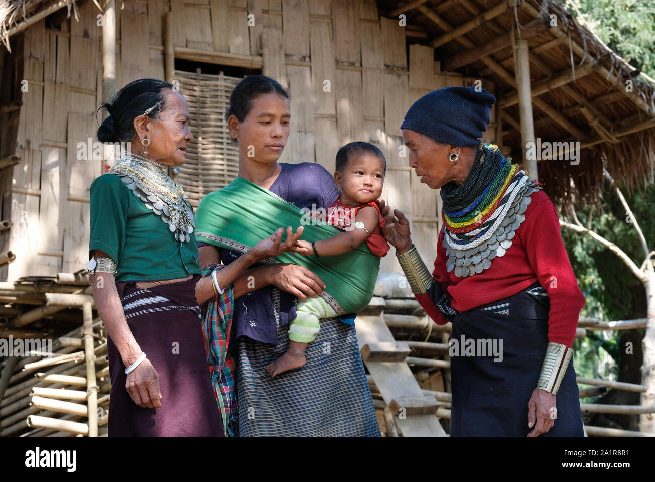 Women of the Reang tribe in front of a traditional house in the village ...