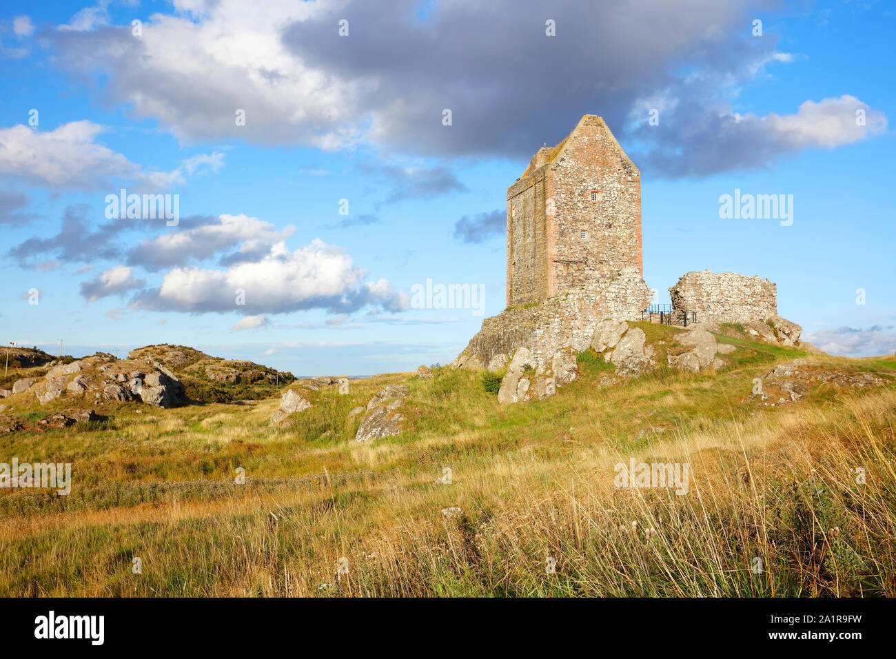 Smailholm Tower bathed in evening light with blue sky and clouds, Scottish Borders, Scotland, United Kingdom. Stock Photo