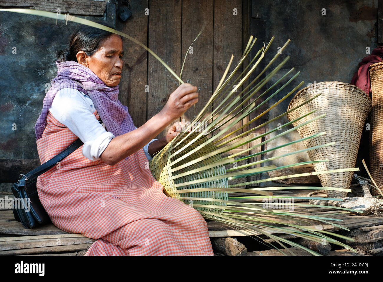 Woman is weaving basket of bamboo. Village Khrang, KhasiHills, state