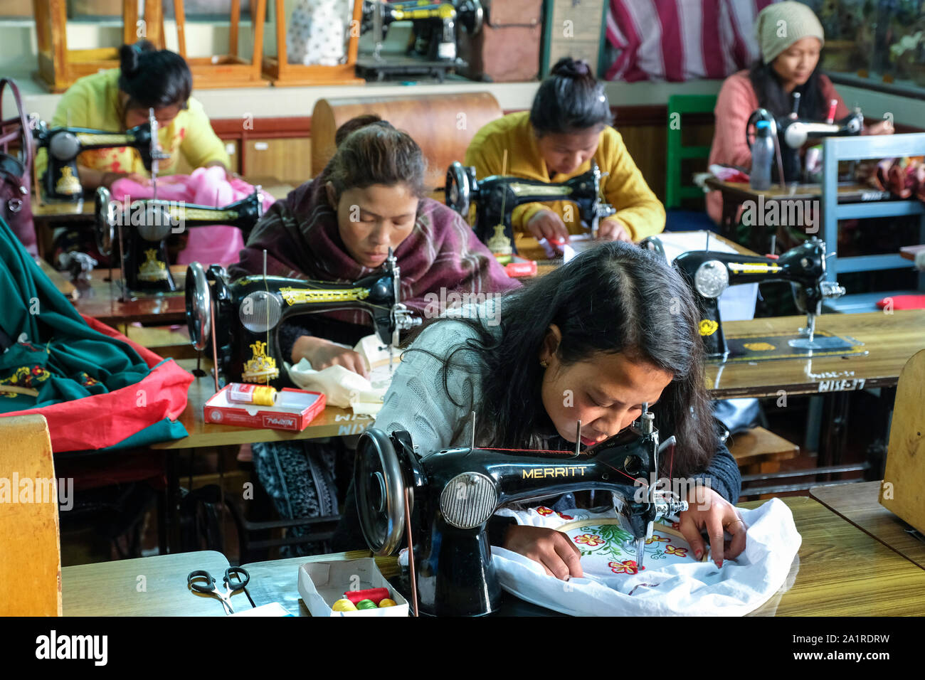 Women on sewing machines at NGO WISE (Women for Integrated Sustainable Empowerment) in Shillong, Meghalaya State, Northeast India Stock Photo