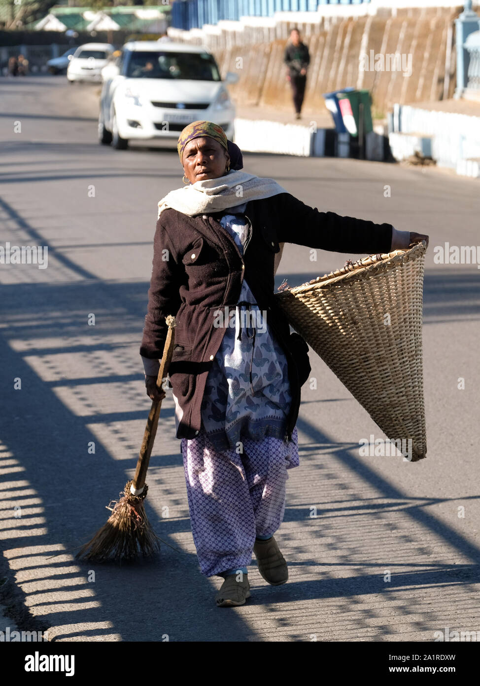 Street sweeper with a woven basket in Shillong, Meghalaya State, Northeast India Stock Photo