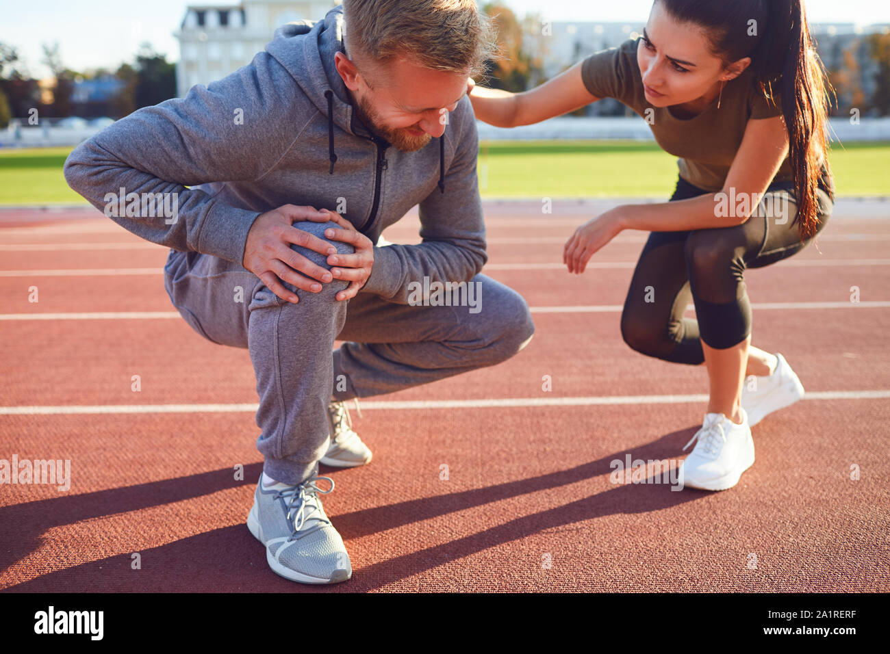 Knee injury in training. A male injured his leg during exercise. Stock Photo