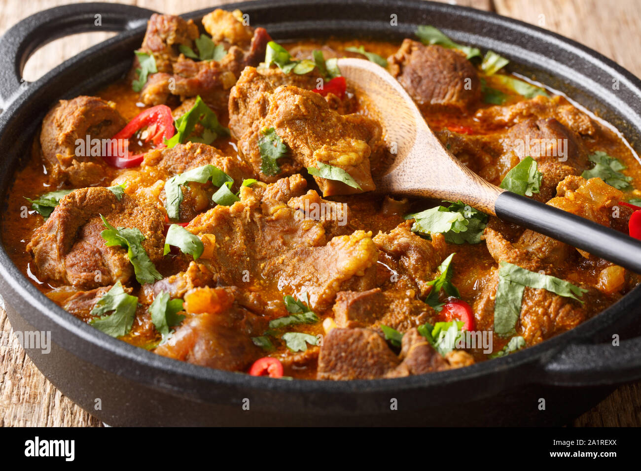 Indian traditional food Lamb rogan josh close-up in a pan on the table. horizontal Stock Photo