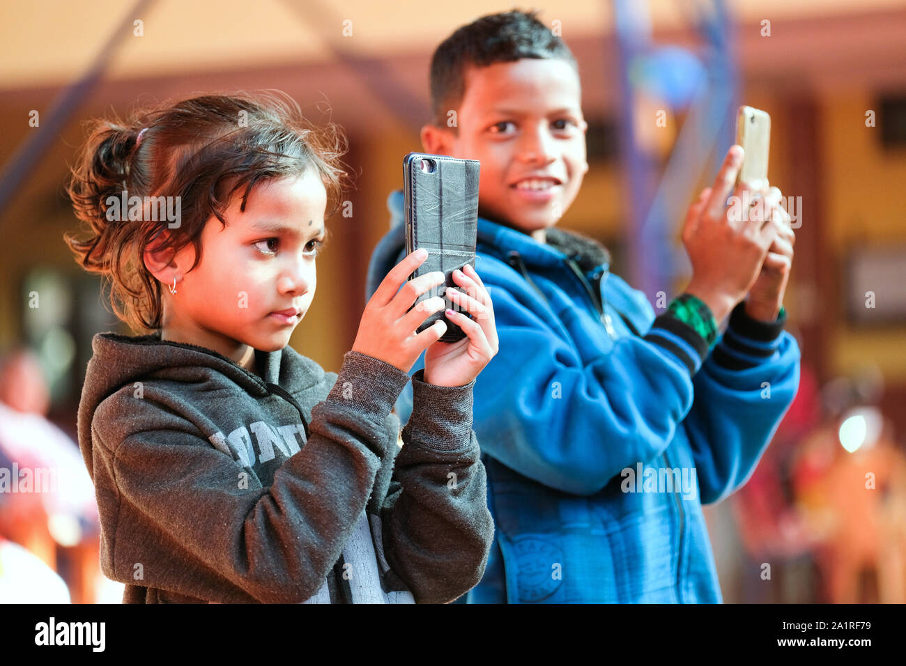 Children play and take pictures with their smartphones. Village Balipara, Assam state, India Stock Photo