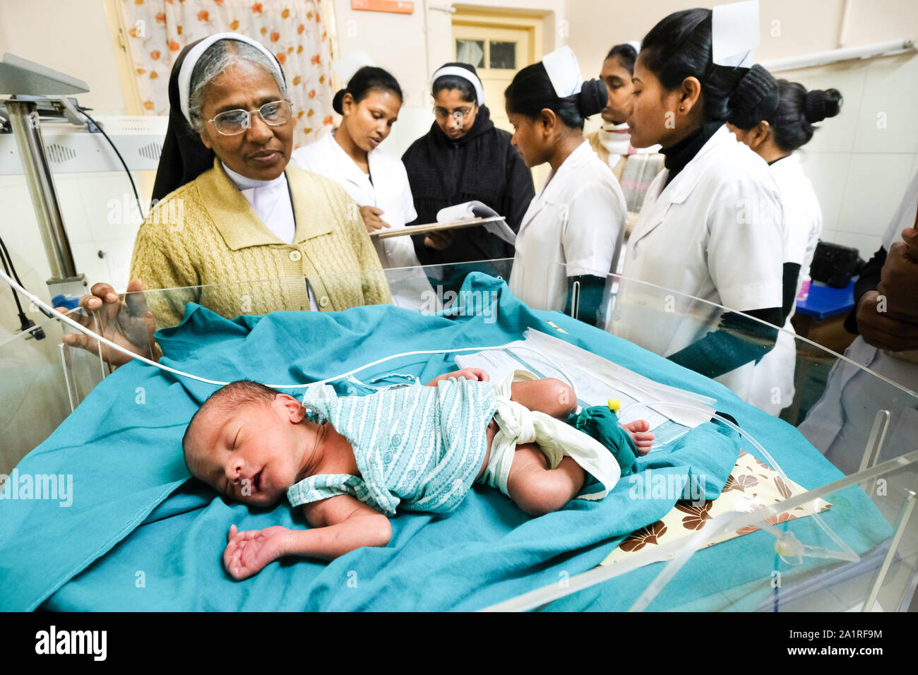 Doctors and nurse sisters at the bed of a premature baby in the catholic Seva Nidas Hospital in Dhekiajulil. Federal State Assam, Northeast India, Asia Stock Photo