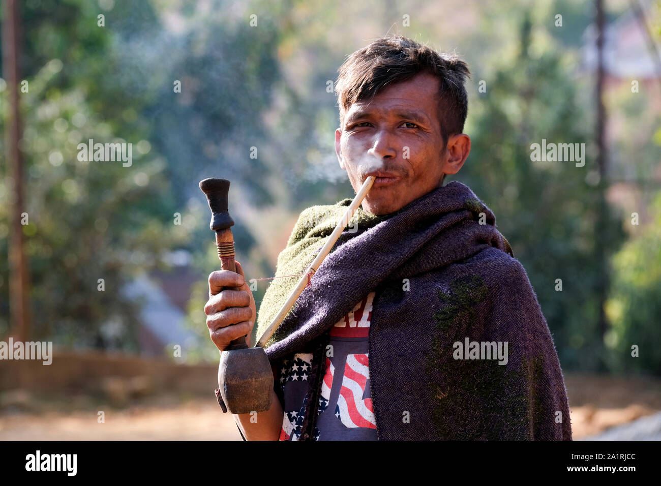Pipe smoking man in the village Khrang, Khasi-Hills, state of Meghalaya, India Stock Photo