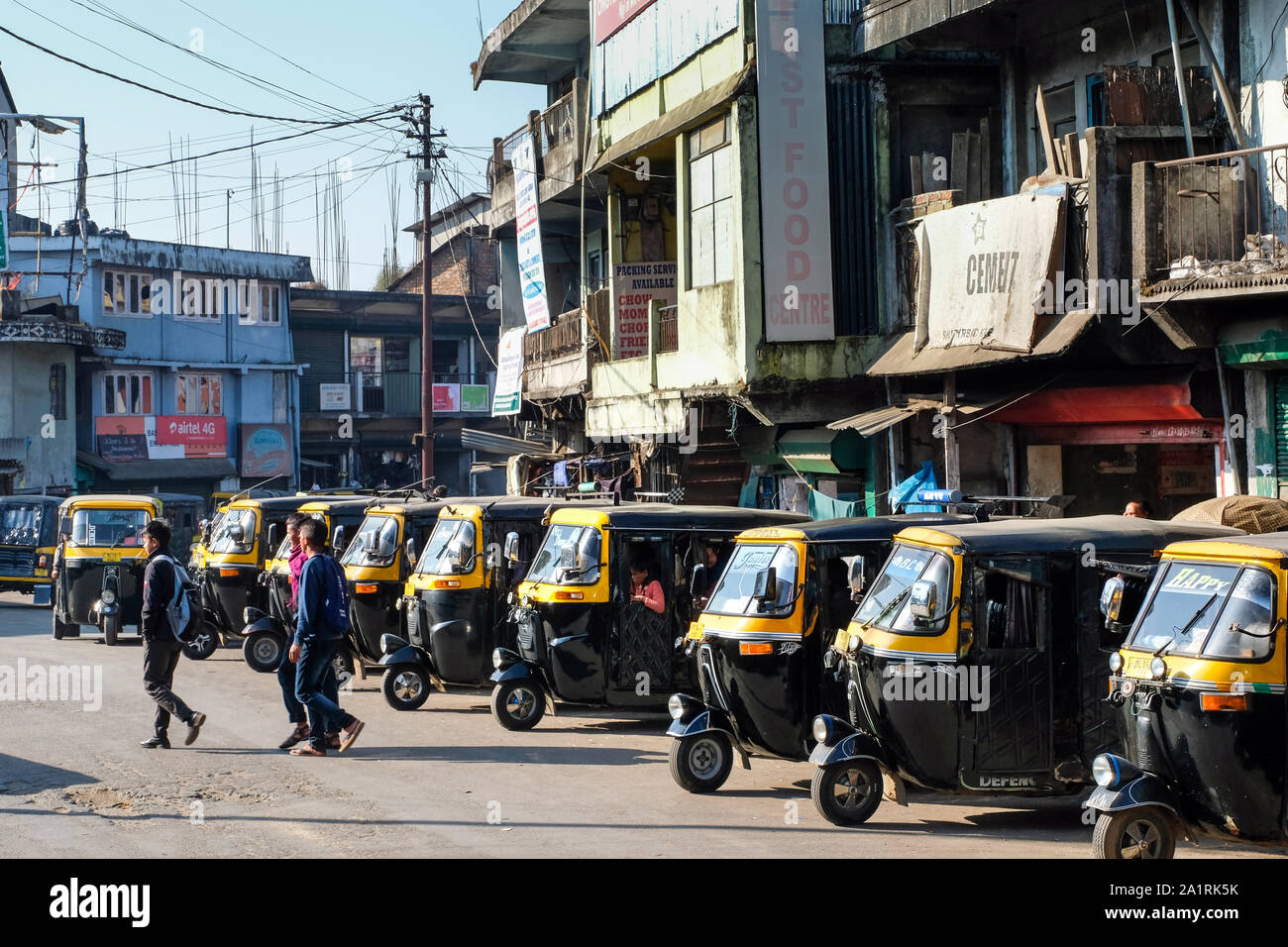 Three-wheelers wait for customers at a taxi rank in Mairang City. State of Meghalaya, Northeast India Stock Photo