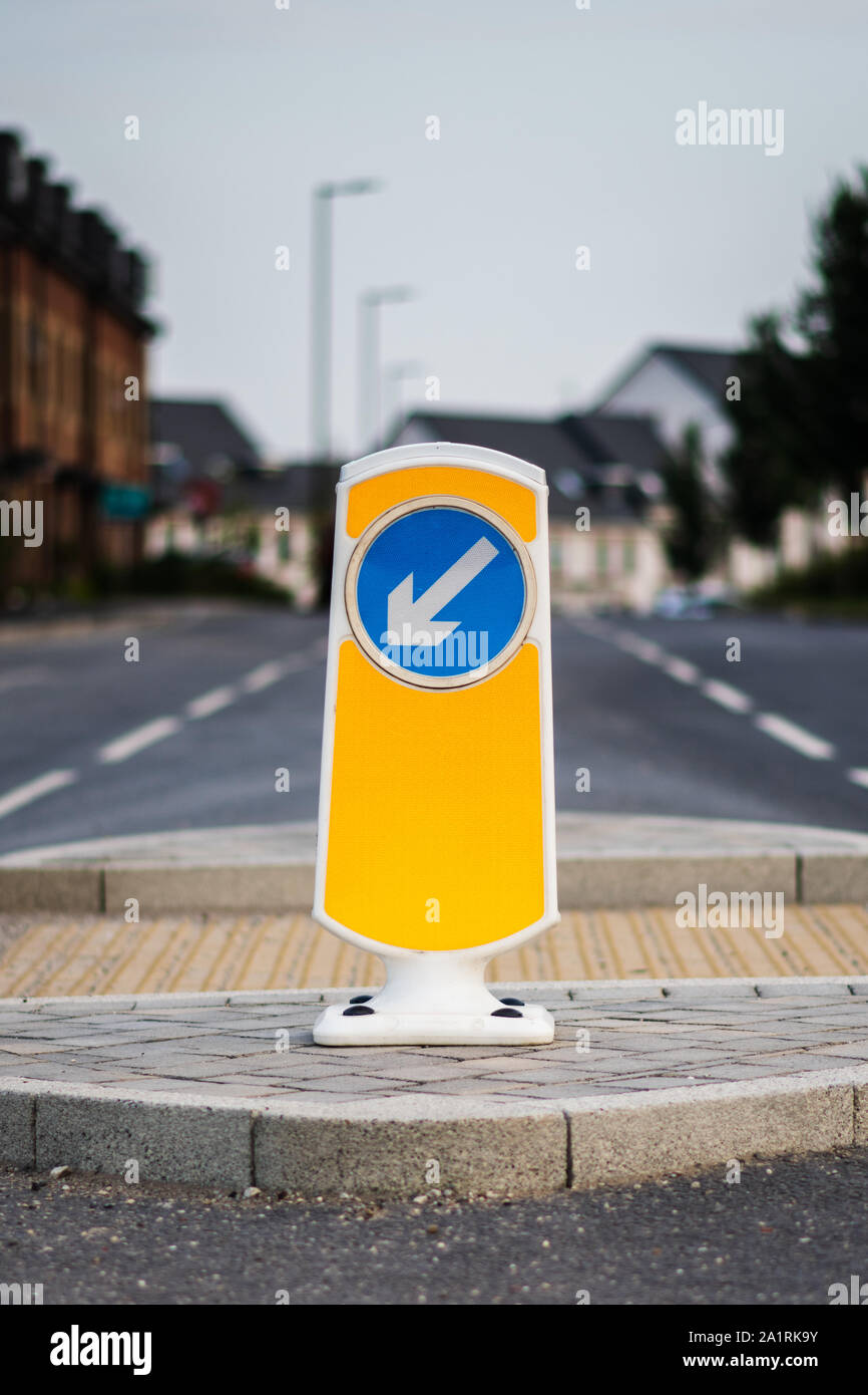 Close up of yellow road crossing sign on pedestrian refuge island in the UK Stock Photo
