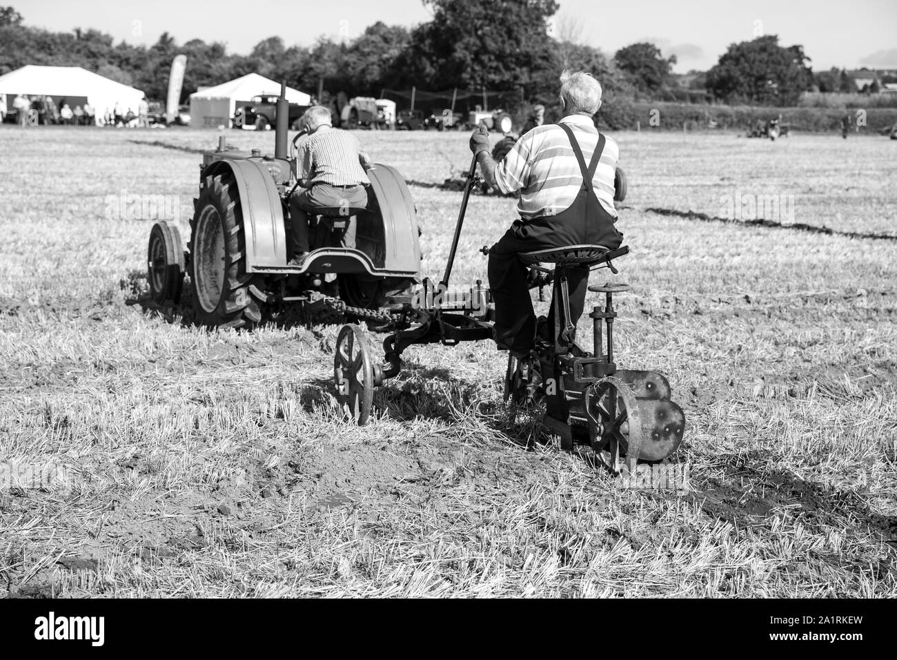 2 Farmers Ploughing using a John Deere General Purpose Vintage Tractor at the Chew Stoke Vintage Tractor and Ploughing Display 2019 Stock Photo