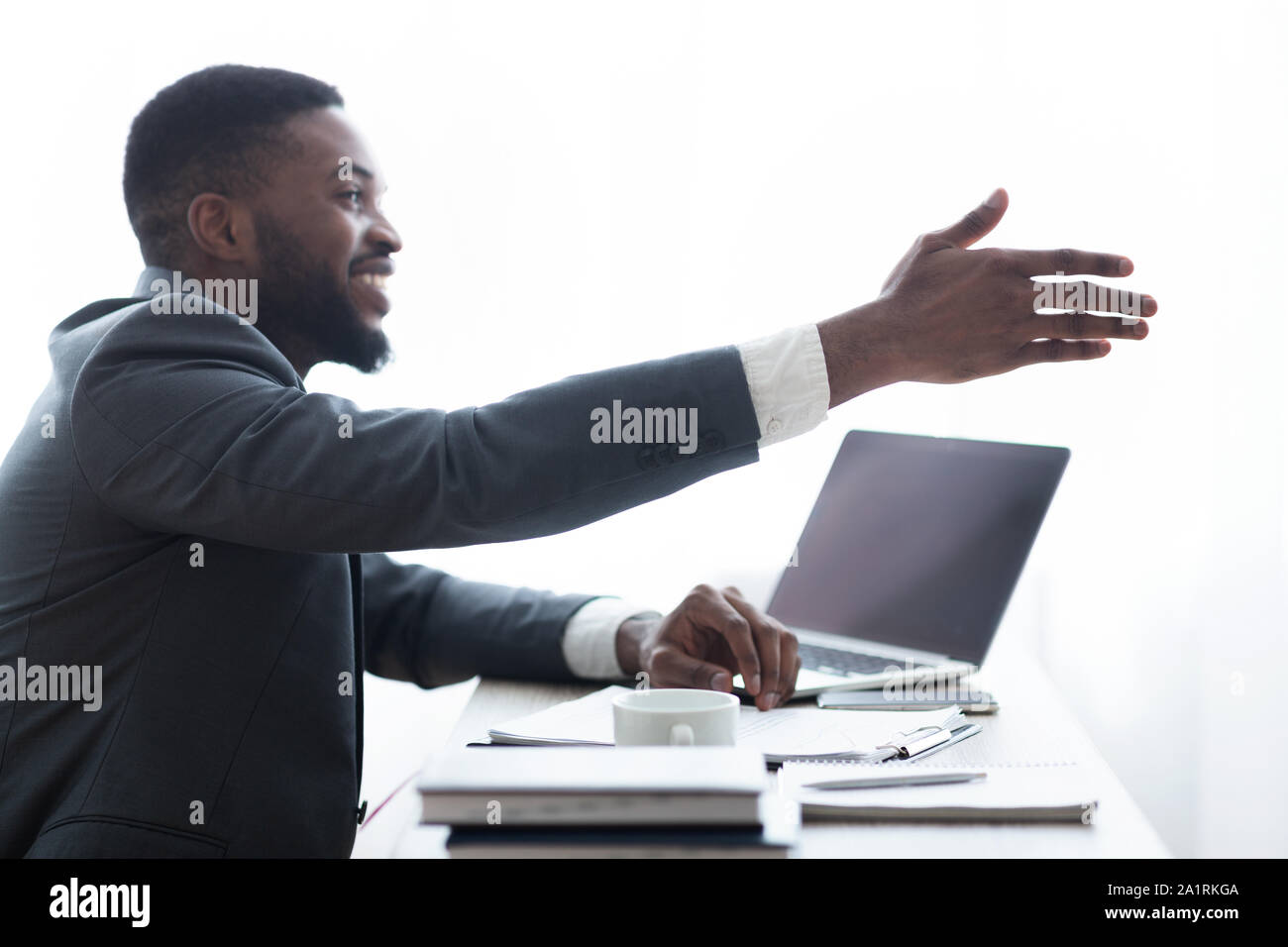 Friendly HR manager extending hand for handshake after successful interview Stock Photo