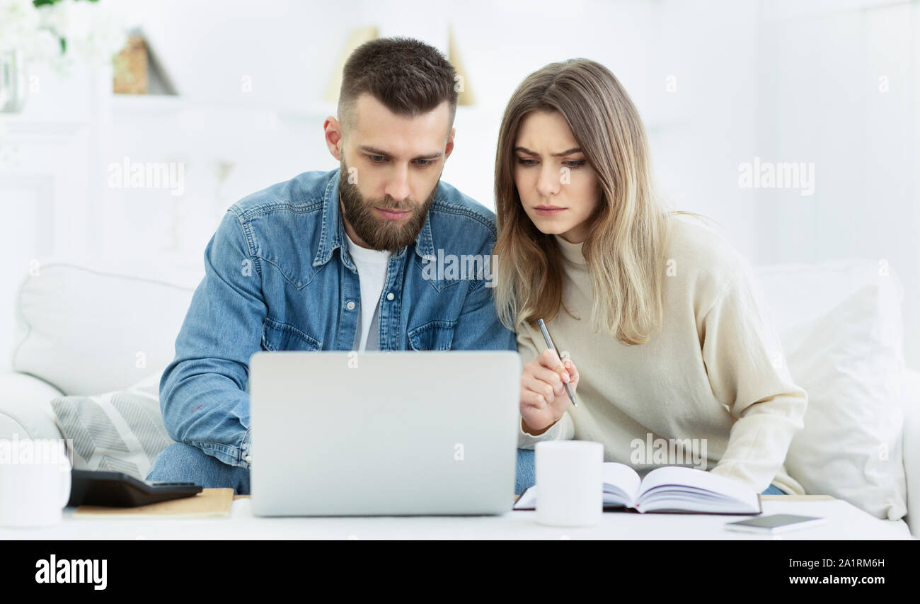 Young couple planning family budget with laptop Stock Photo