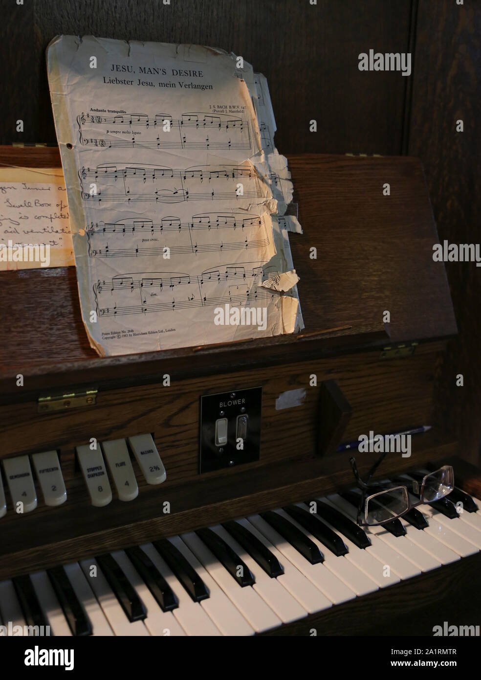 Ragged sheet music on church organ with spectacles on keyboard Stock Photo  - Alamy
