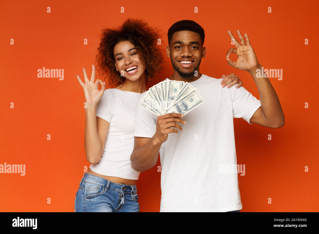 Happy African Man And Woman Gesturing Ok Sign With Lots Of Money