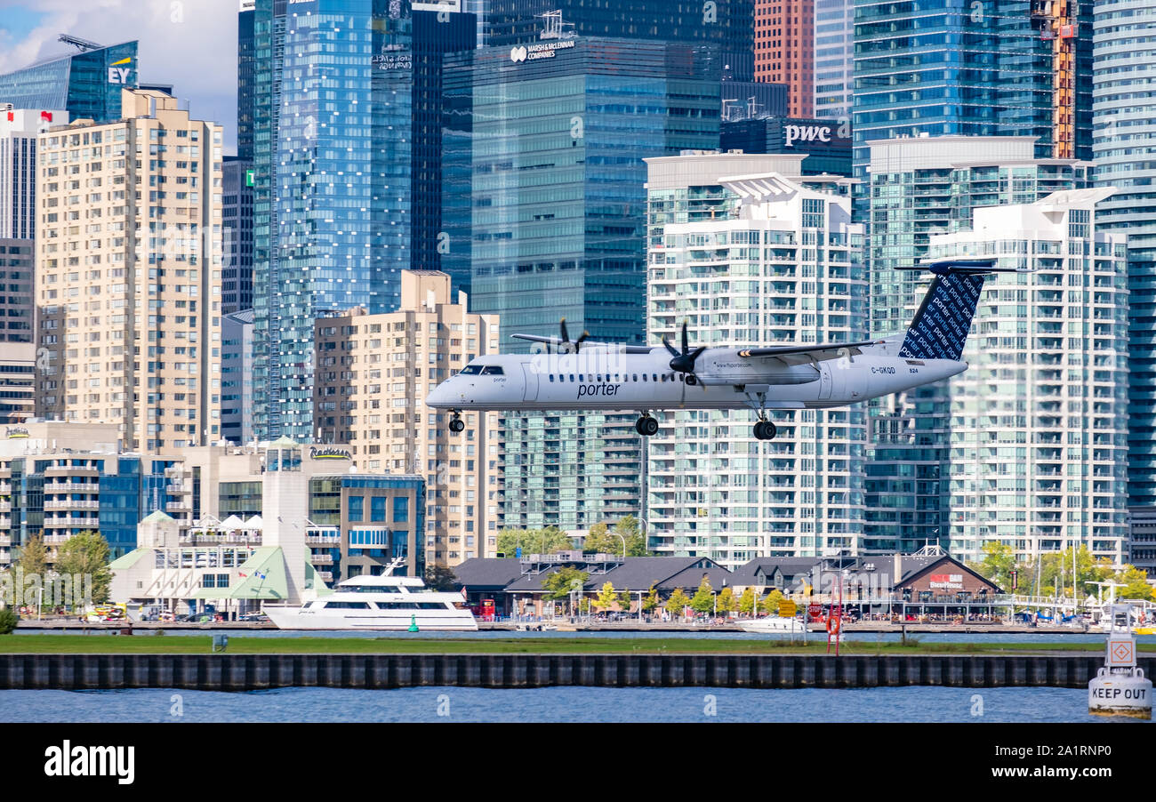 Porter Airlines Bombardier Q400 aircraft on its final approach to Bill Bishop Airport in downtown Toronto Ontario Canada. Stock Photo