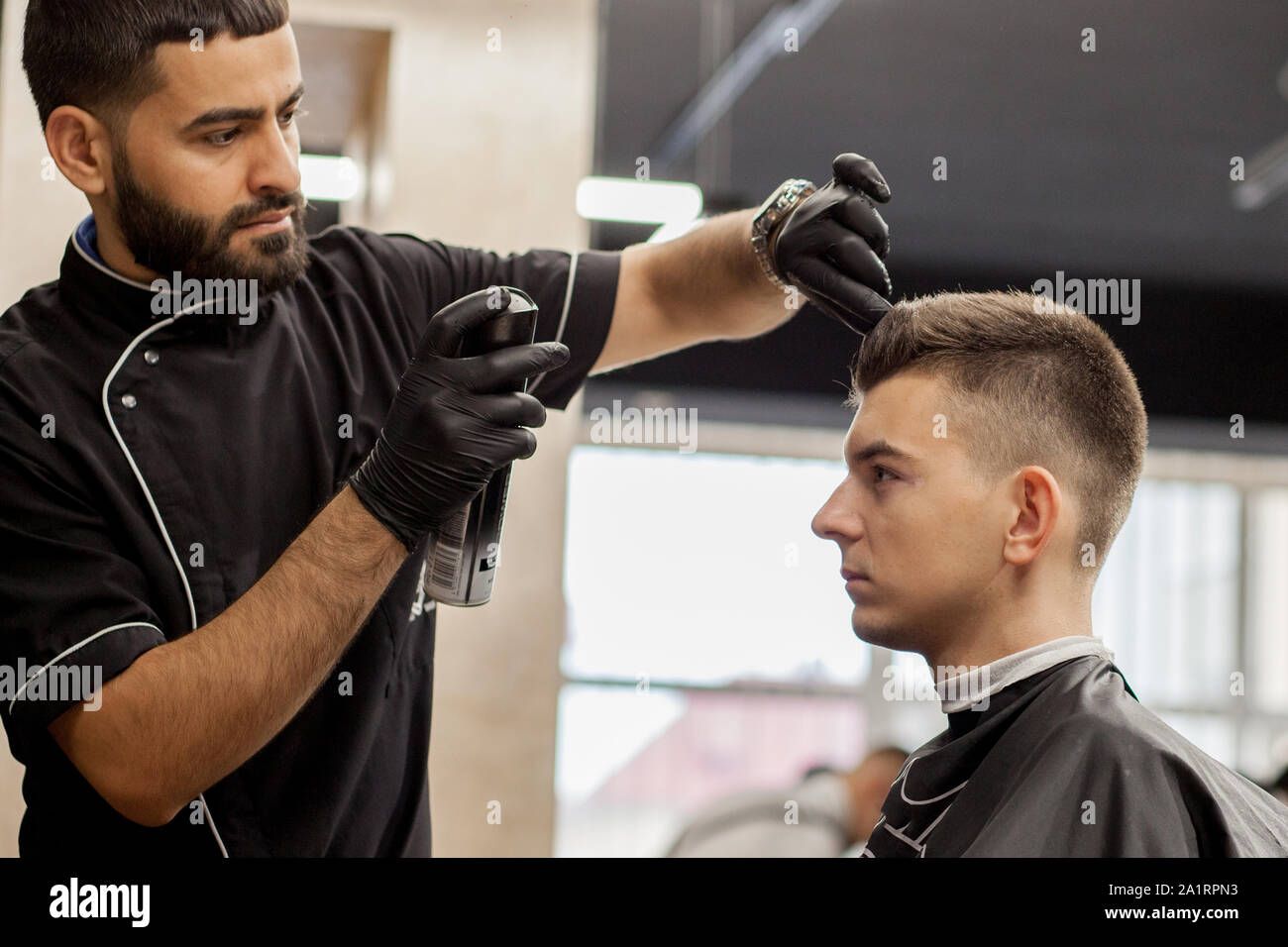 Brutal Guy In Modern Barber Shop Hairdresser Makes Hairstyle A