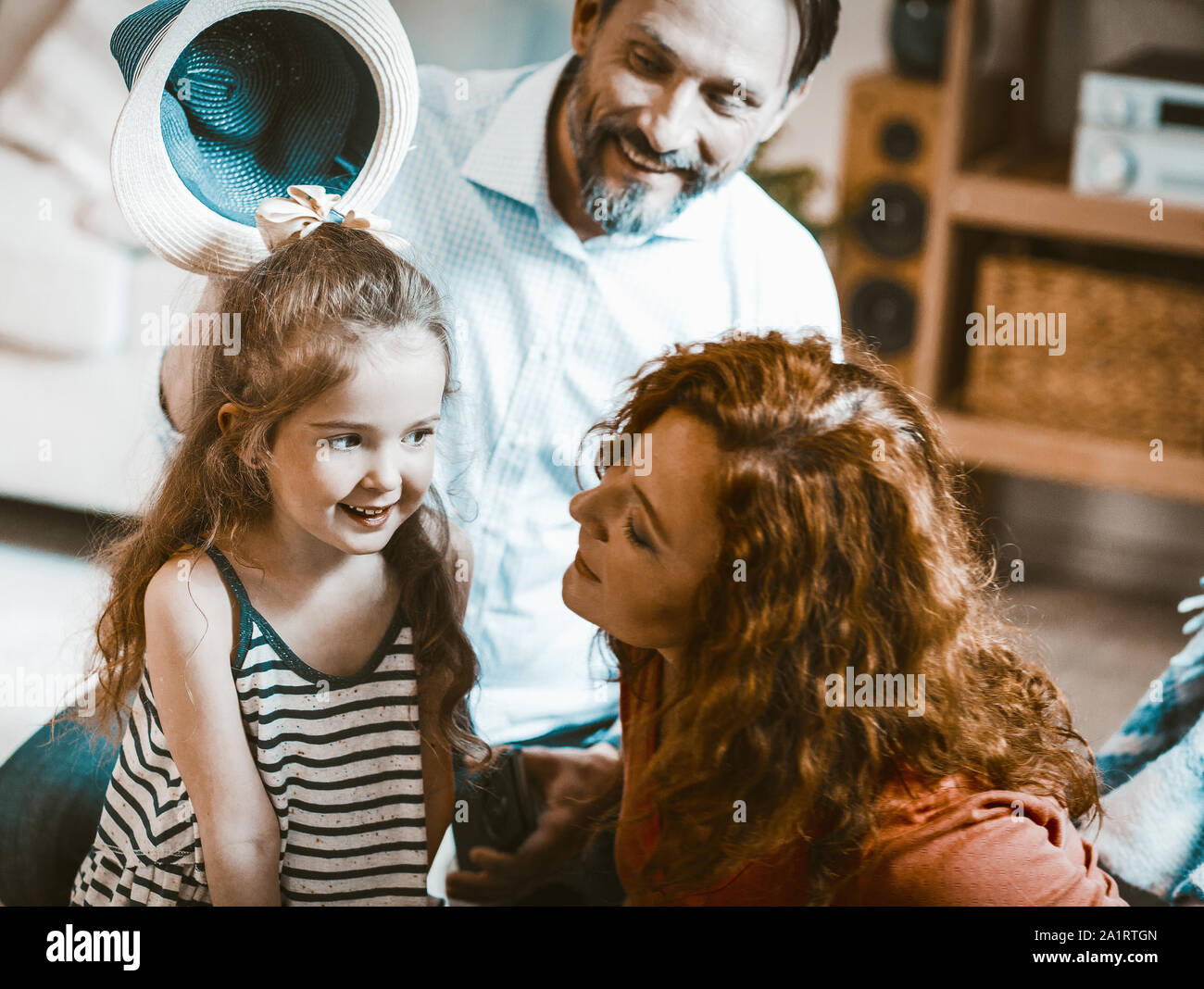 Family portrait mom dad and cute liitle daughter. Stock Photo