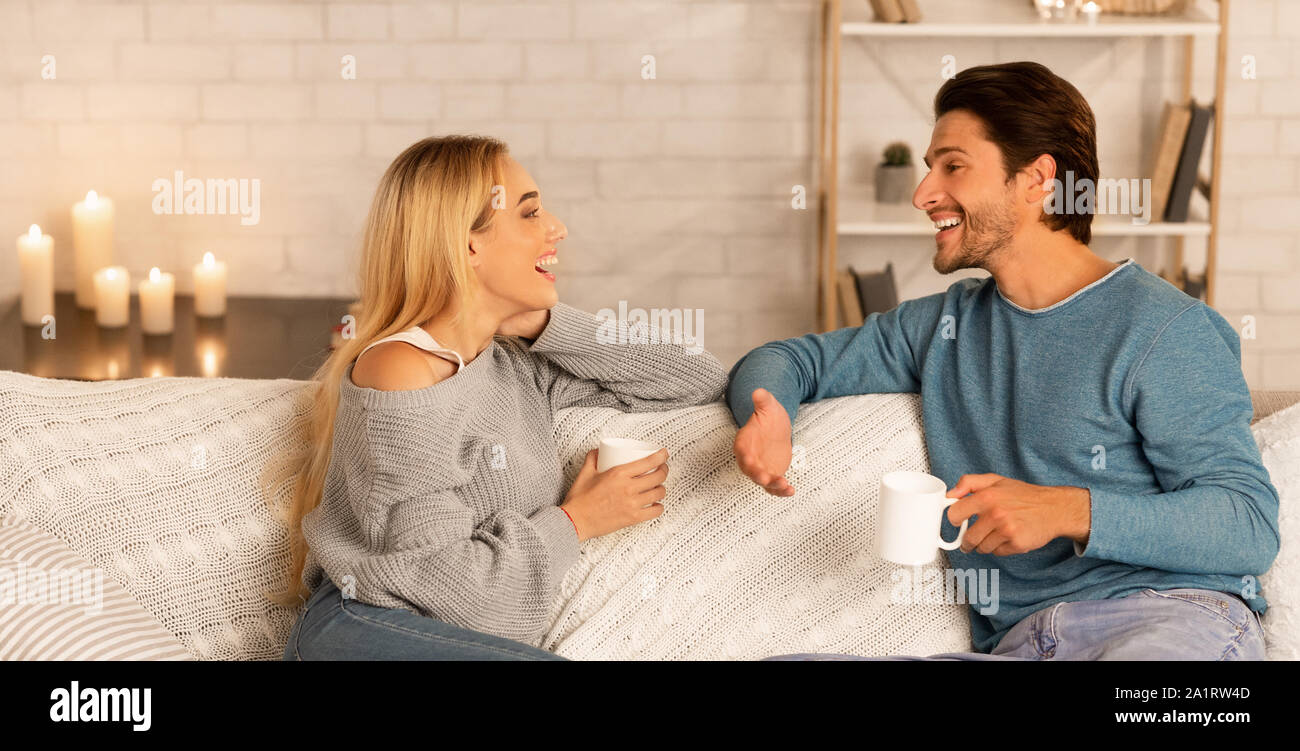 Man And Woman Having Stay-At-Home Date At Night, Panorama Stock Photo
