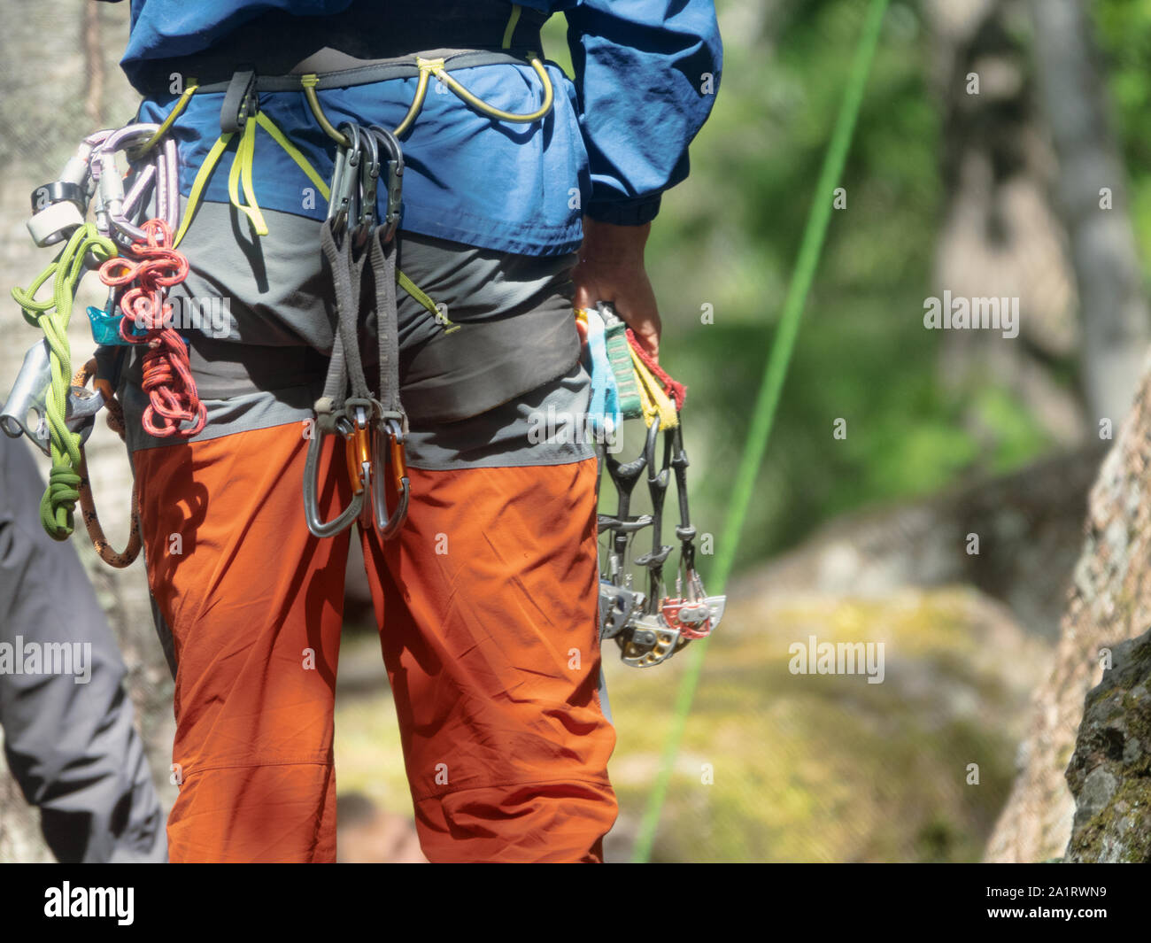 Climber partner insures. Quickdraw, carabiner hanging on a safety ...