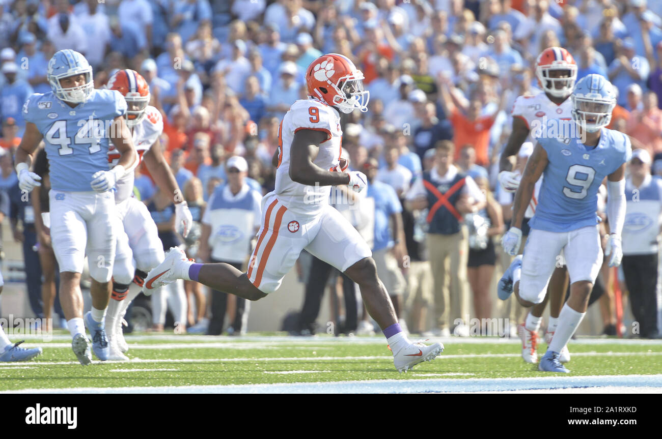 Chapel Hill, North Carolina, USA. 28th Sep, 2019. TRAVIS ETIENNE, center, of Clemson breaks through the Tar Heels' defense, JEREMIAH GEMMEL (44) and CAM'RON KELLY, right, to score a touchdown for the Tigers. The North Carolina Tar Heels played the Clemson Tigers in a football game that took place at the Kenan Memorial Stadium in Chapel Hill, N.C. on Saturday, September 28, 2019. The game is tie 14-14 at half time. Credit: Fabian Radulescu/ZUMA Wire/Alamy Live News Stock Photo