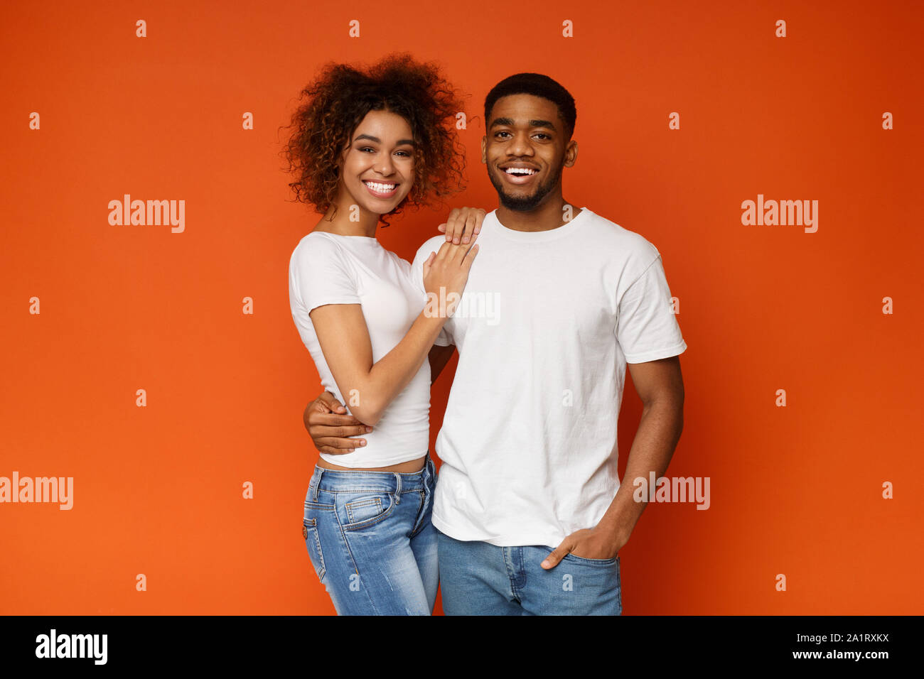 Happy african american couple embracing and smiling Stock Photo - Alamy