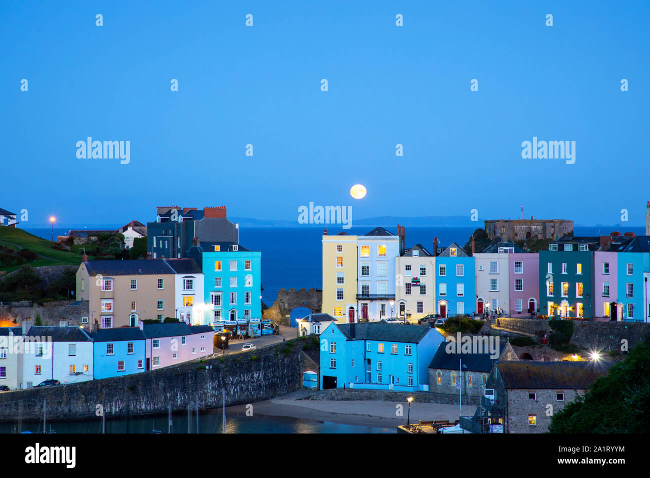 TENBY, WALES - SEPTEMBER 13Th 2019: Full moon is shining over historic ...