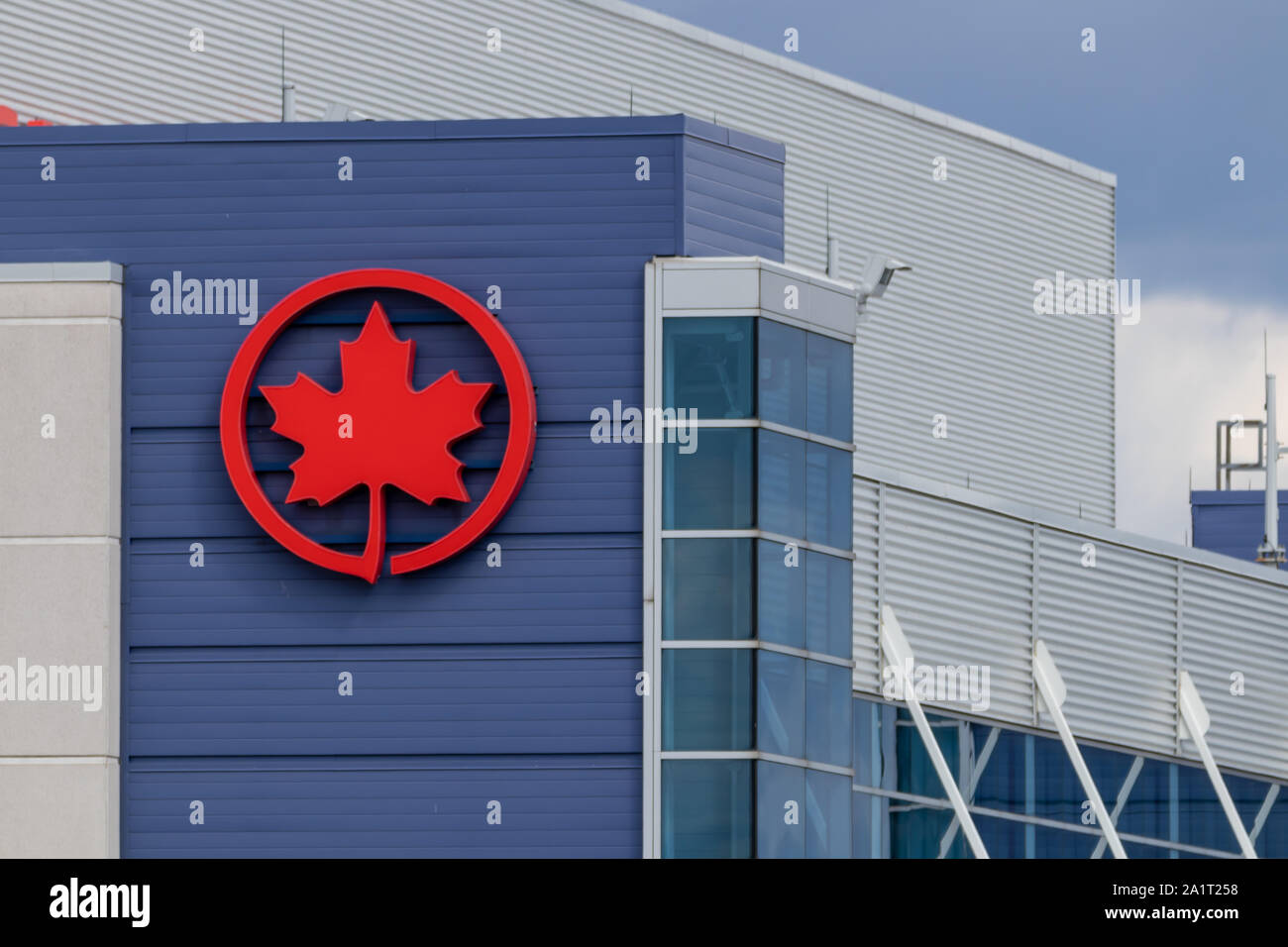 Air Canada icon logo on the side of a building at Toronto Pearson Intl. Airport. Stock Photo