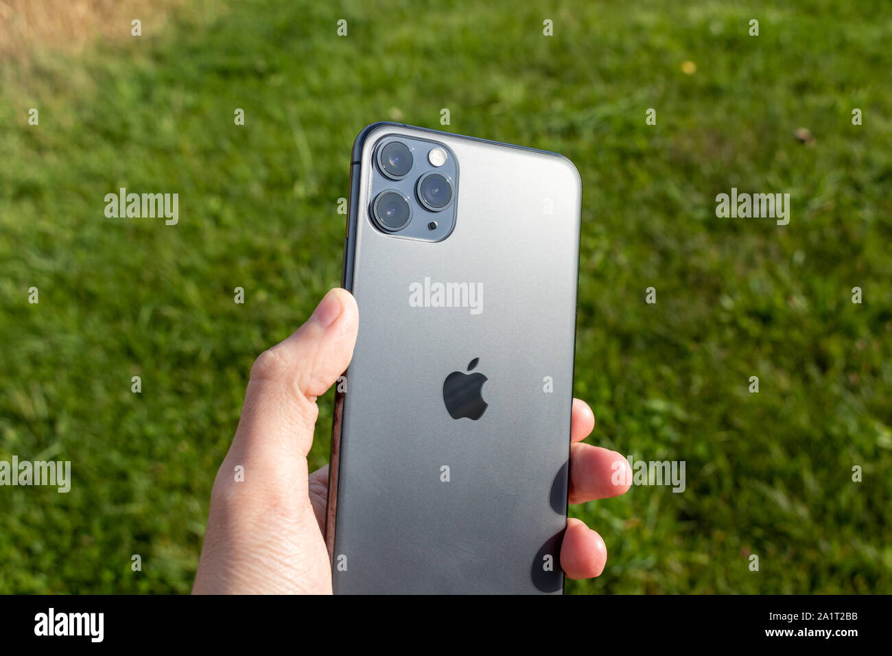 Man holding an iPhone 11 Pro Max on a sunny day Stock Photo - Alamy