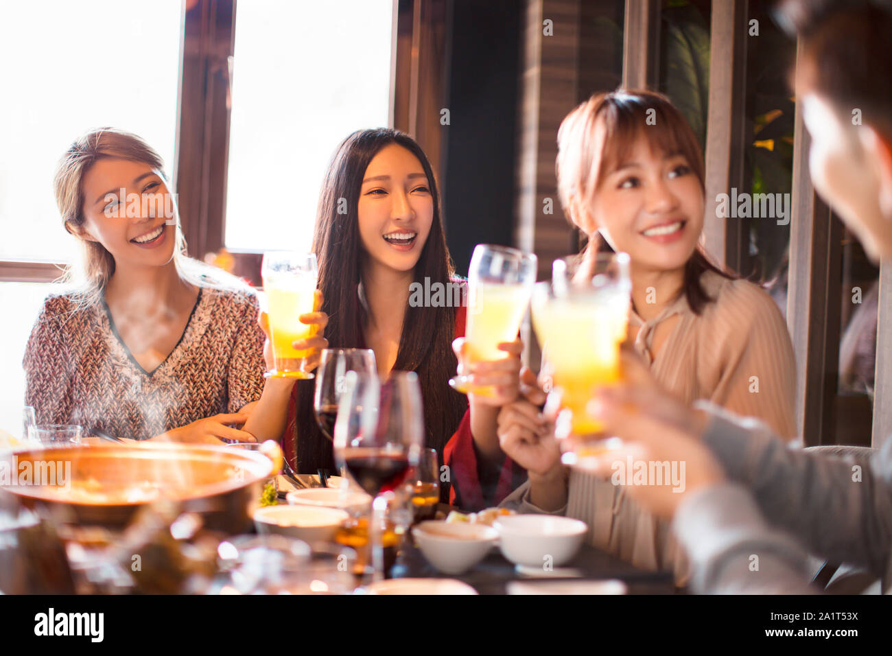 happy young friends eating hot pot in restaurant Stock Photo
