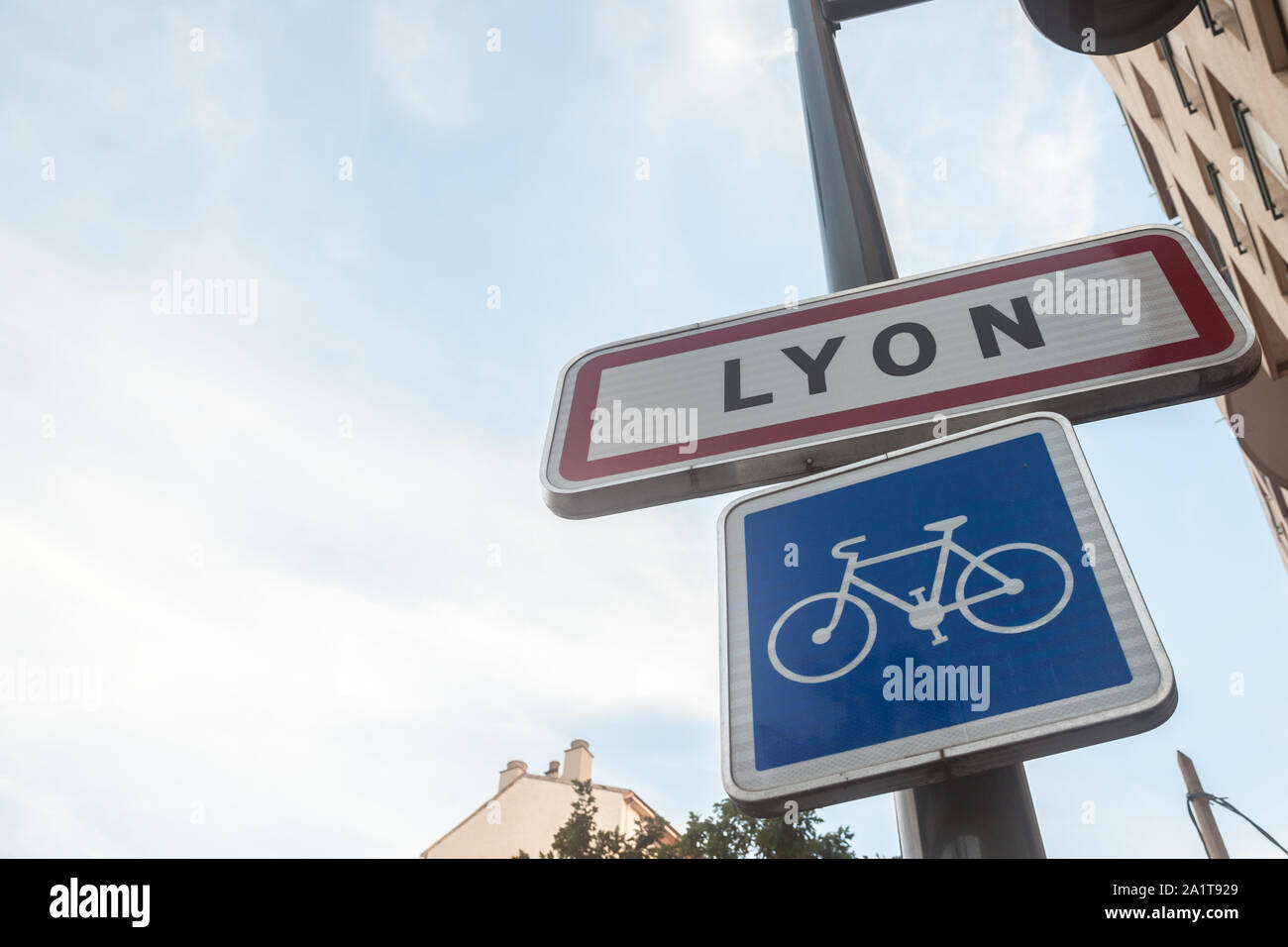 LYON, FRANCE - JULY 17, 2019: Roadsign indicating the entrance to Lyon with a bicycle sign. This sign is a standard French plate visible at every entr Stock Photo