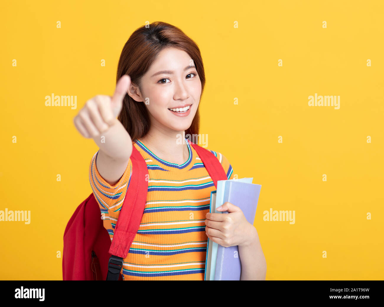 Portrait of beautiful asian student holding books Stock Photo - Alamy
