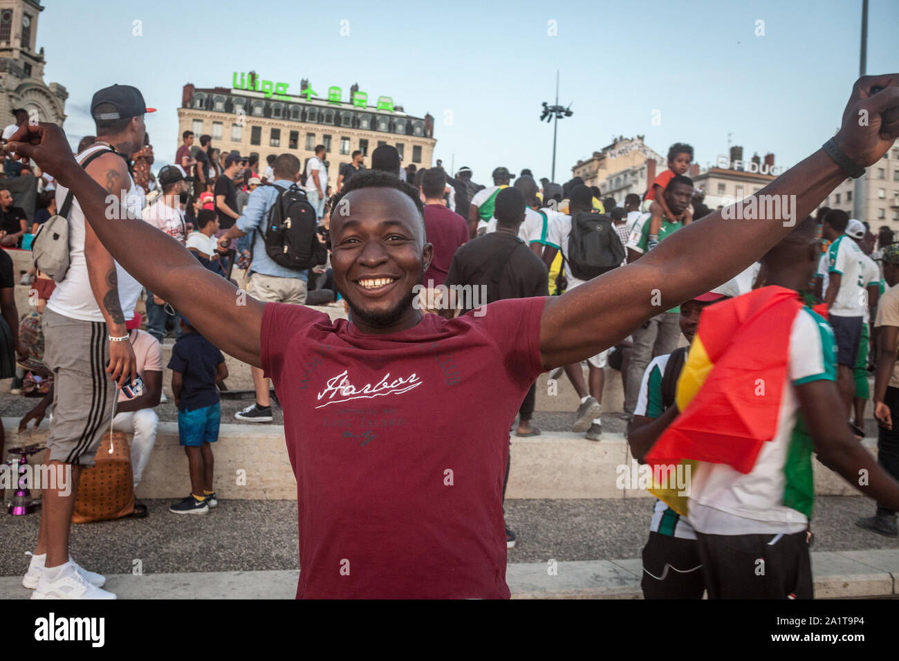 LYON, FRANCE - JULY 14, 2019: Senegal supporter, a black man, cheering and smiling celebrating the qualification of the Senegal Football team for the Stock Photo
