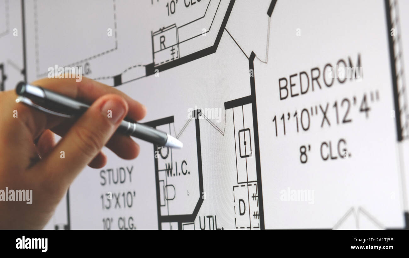 blueprint monitor hand pen explain plan of residential house apartment building on screen Stock Photo