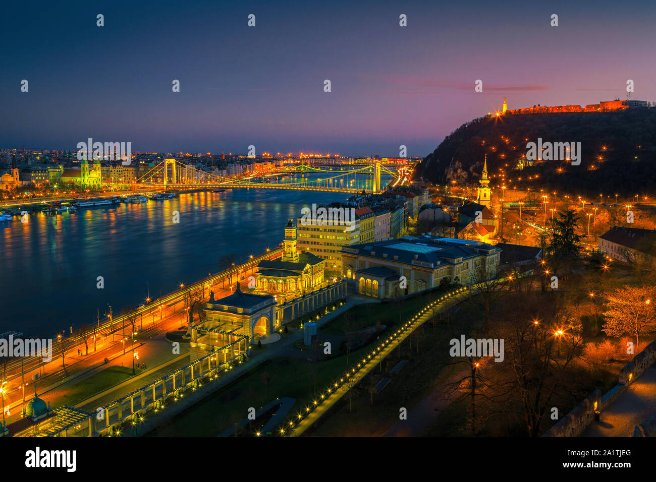 Picturesque European travel location. Beautiful evening cityscape panorama with fantastic illuminated Elisabeth bridge and Danube river at colorful su Stock Photo