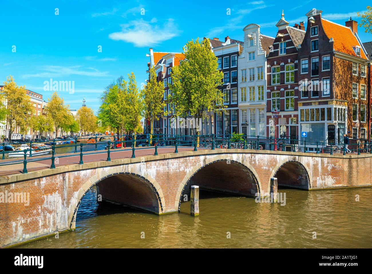 Picturesque travel and touristic location. Beautiful water canals and waterways with spectacular traditonal dutch buildings, Amsterdam, Netherlands, E Stock Photo